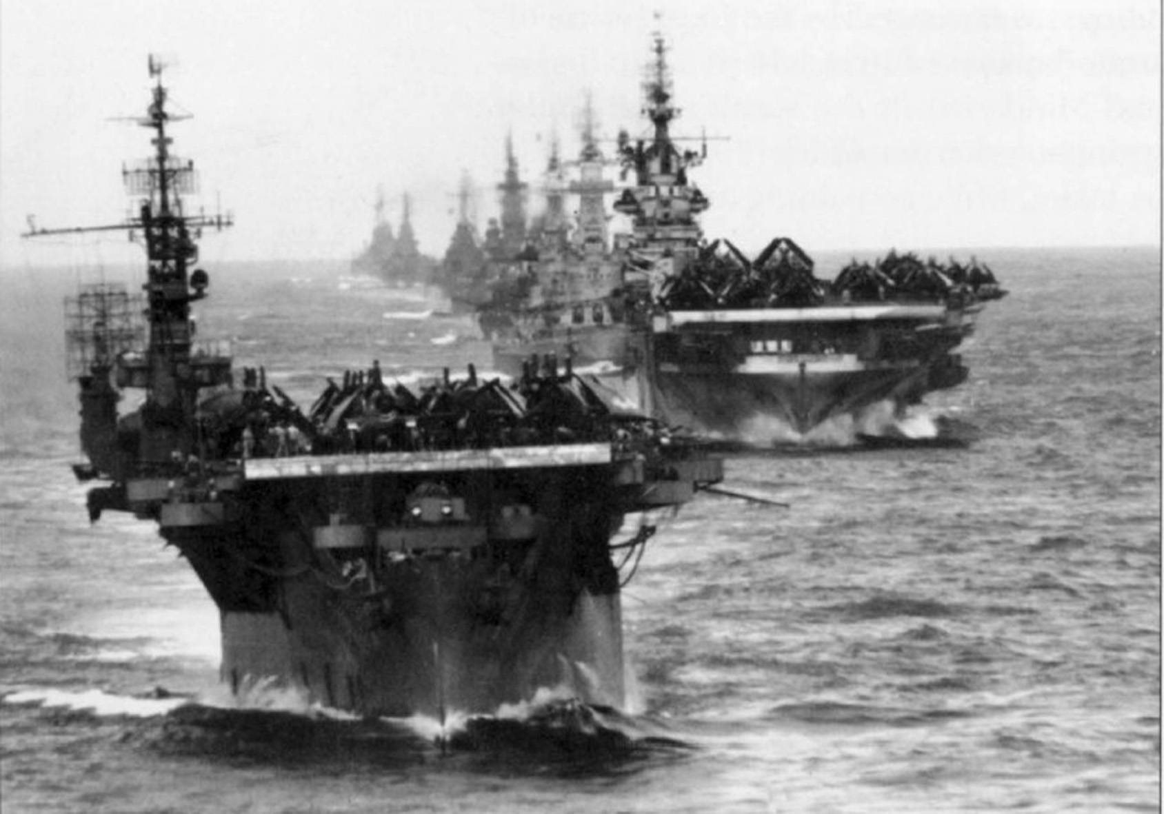 懷舊戰艦照片 壁紙 — 一排巨型航空母艦在波濤洶湧的海面上以強而有力的黑白海軍編隊航行。