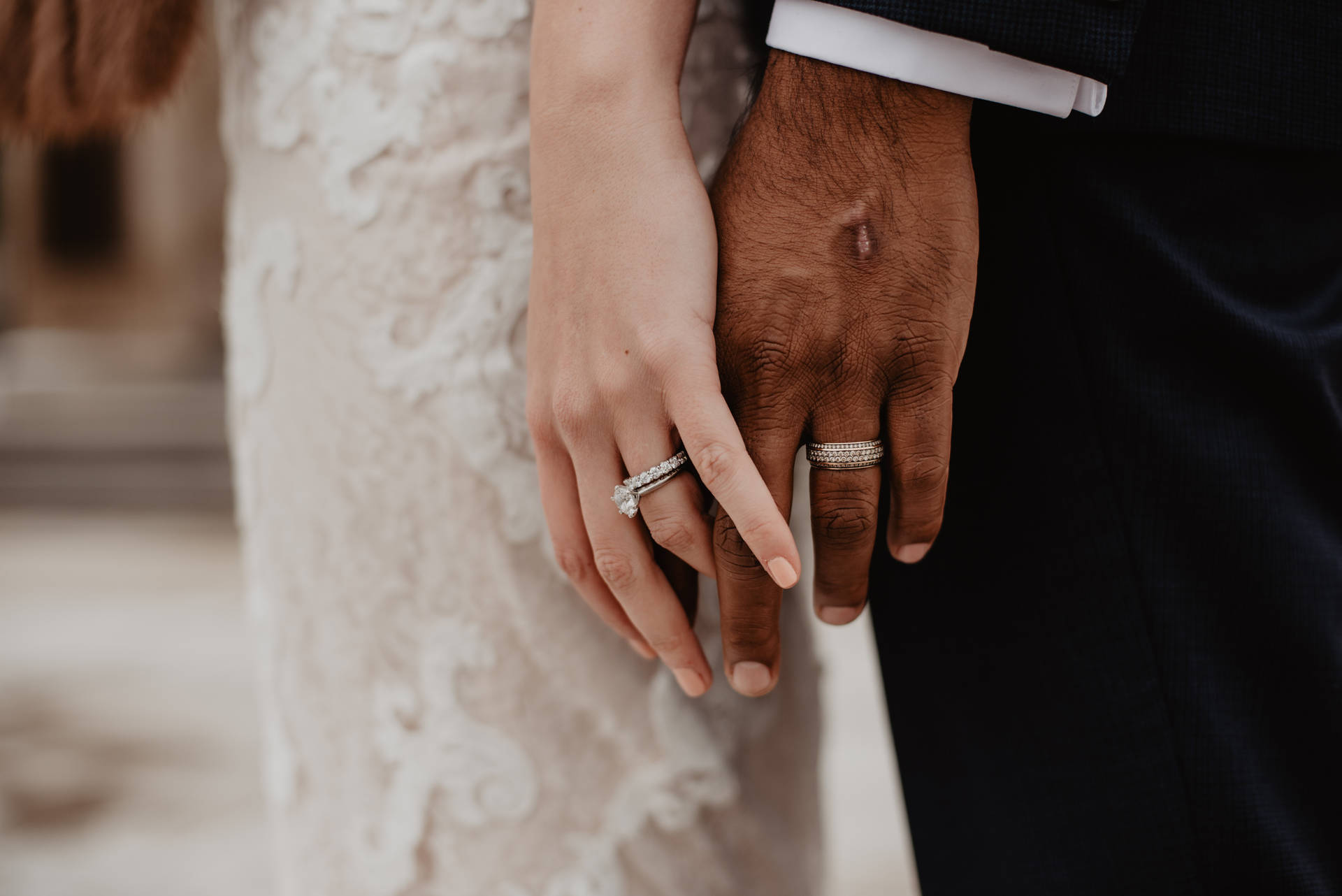 兩隻手互相握住，結婚戒指清晰可見。