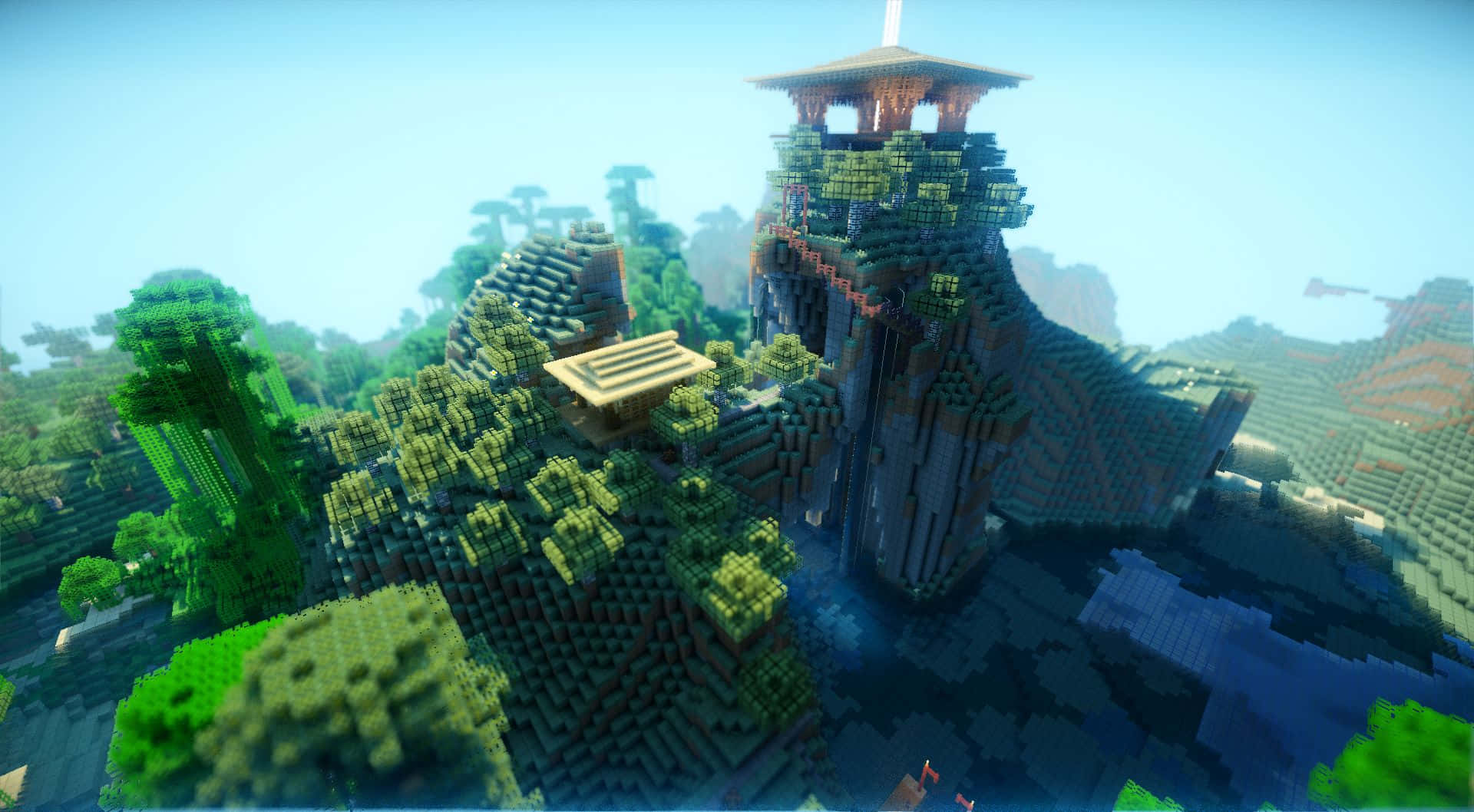《我的世界》光影特效，為遊戲注入全新魅力！ 壁紙 — 一個像素化的Minecraft山頂堡壘，有茂密的綠色樹木和一個木塔，在清澈的藍天下。