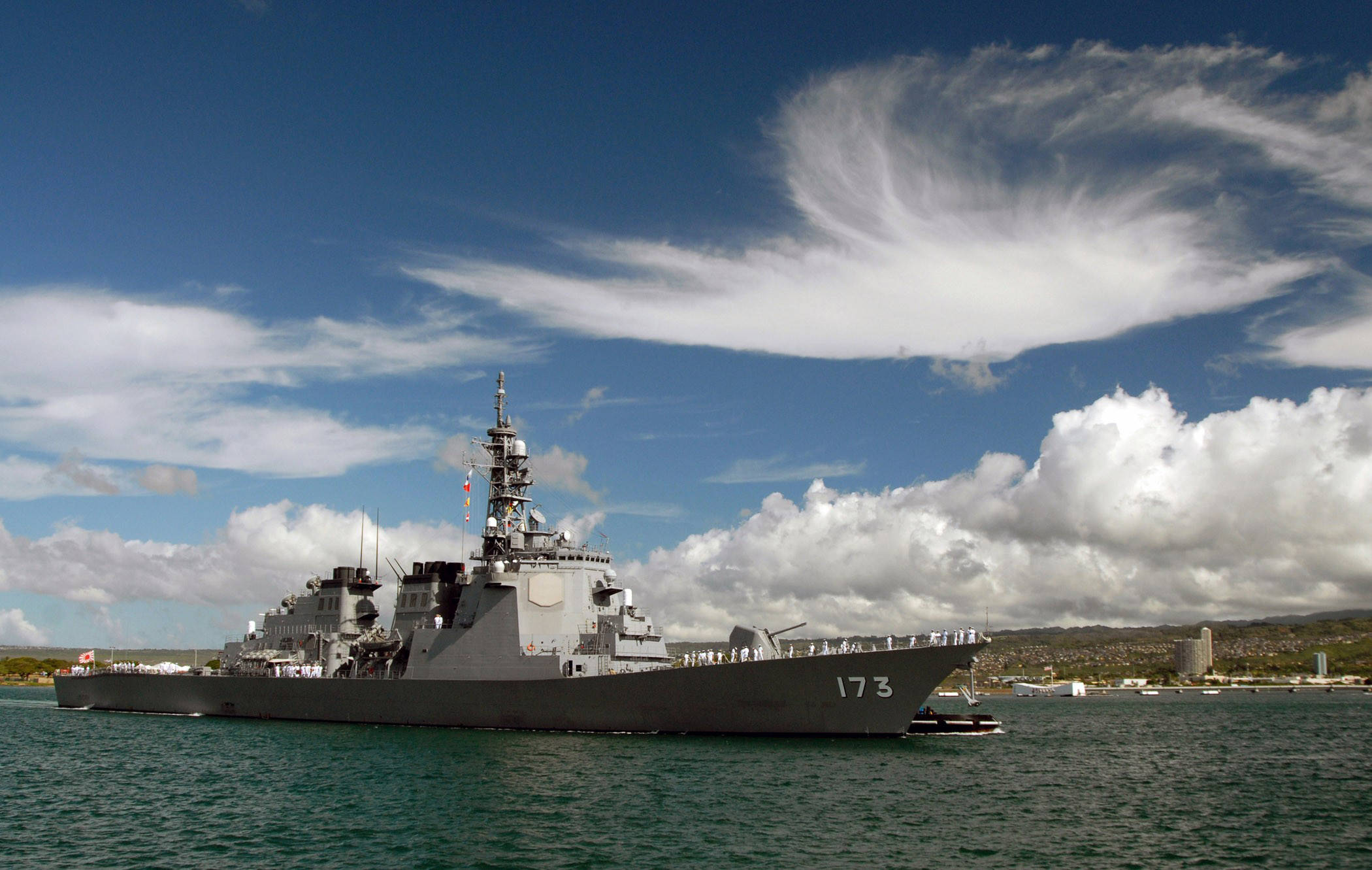 戰艦與多雲藍天 壁紙 — 一艘灰色海軍驅逐艦，船體編號173，在湛藍天空和戲劇性白雲下，平靜地航行在碧綠色的水面上。