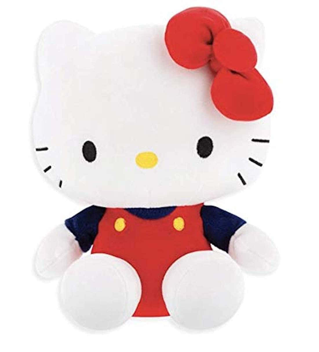 戴上微笑，與 Hello Kitty 一起開心！ 壁紙 — 一個白色毛絨Hello Kitty公仔，戴著紅色蝴蝶結和紅色工人褲，坐在純白色背景前。