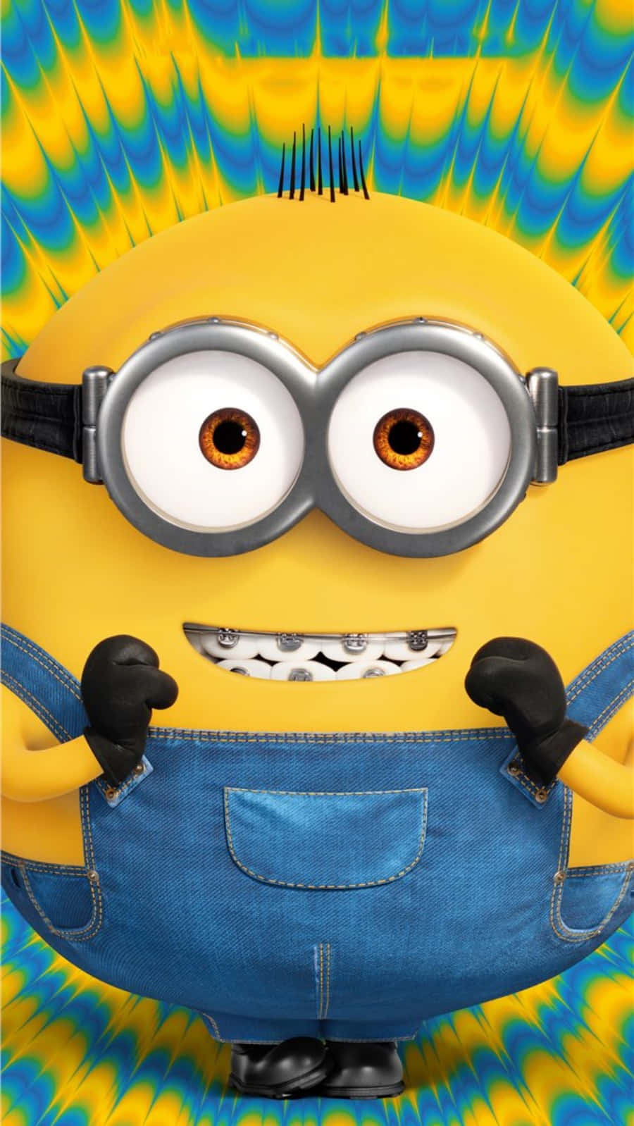 一個戴著護目鏡和牛仔布工裝褲的黃色Minion在色彩繽紛的背景上。