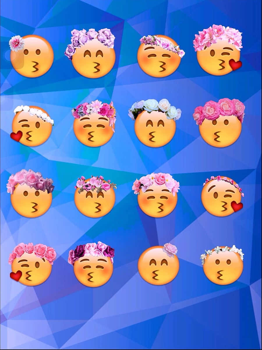 戴花冠的親吻Emoji女孩 壁紙 — 一個由親吻臉表情符號組成的網格，飾以色彩繽紛的花冠，背景為藍色幾何圖案。