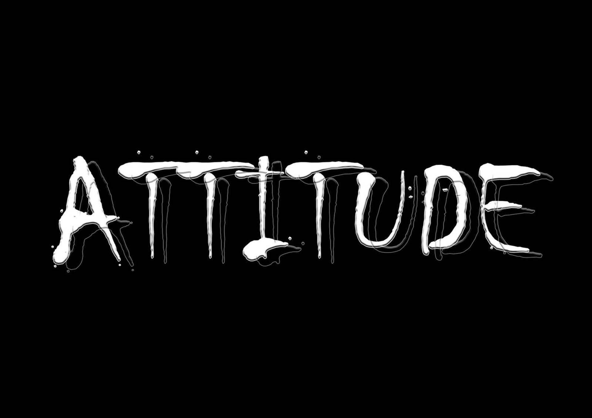在黑色背景上拼出attitude的粗體白色滴落塗鴉文字