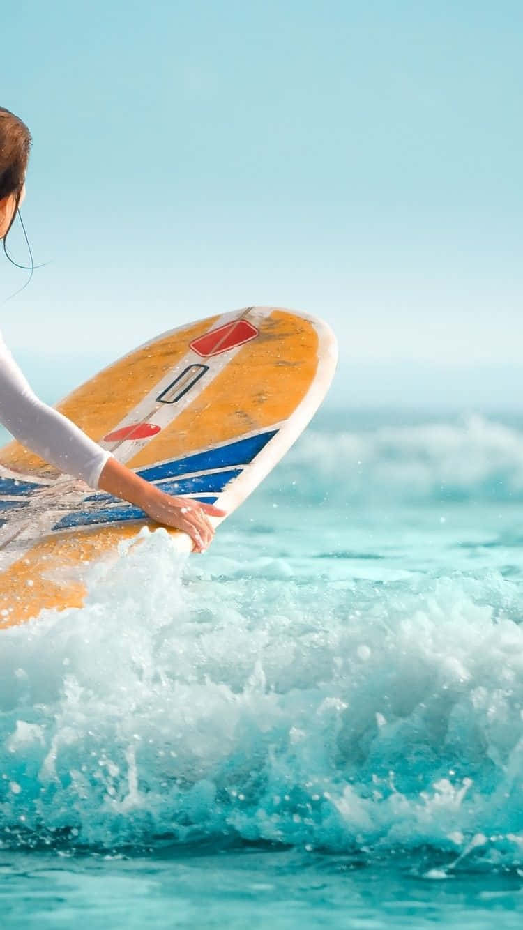 衝浪手在海灘的海浪中拿著衝浪板