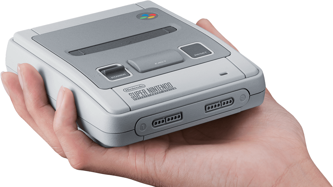手持超級任天堂主機 壁紙 — 一隻手在黑色背景前拿著灰色Super Nintendo Entertainment System主機。