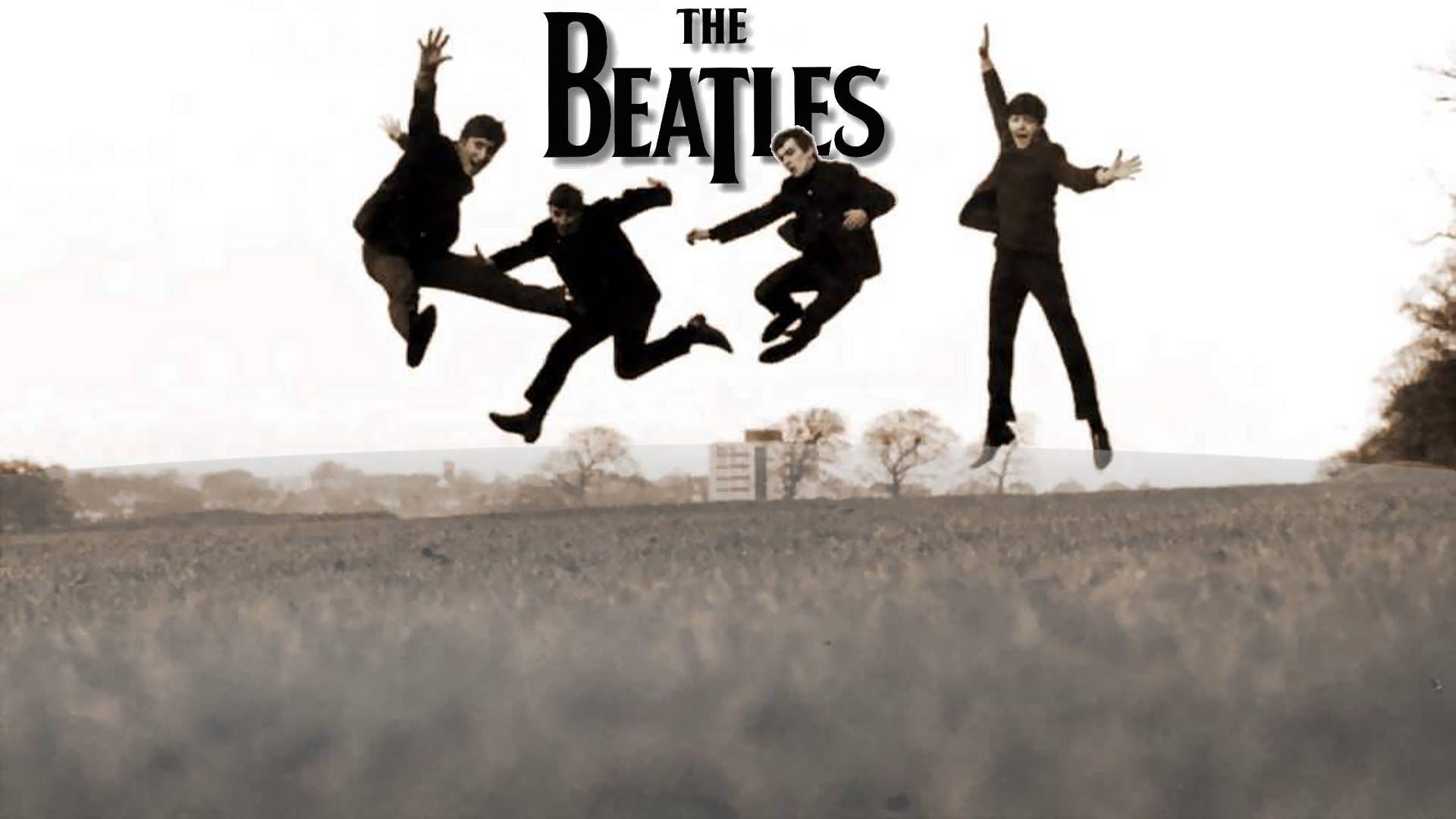 四個身穿黑色西裝的男人在草地上跳躍，上方有「The Beatles」字樣。