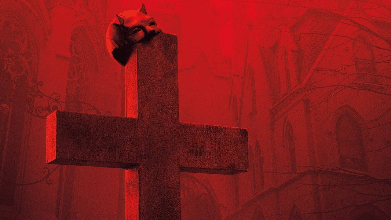 抽象 Daredevil 墓園 壁紙 — 一個惡魔面具棲息在石十字架上，背景是血紅色的哥德式大教堂。