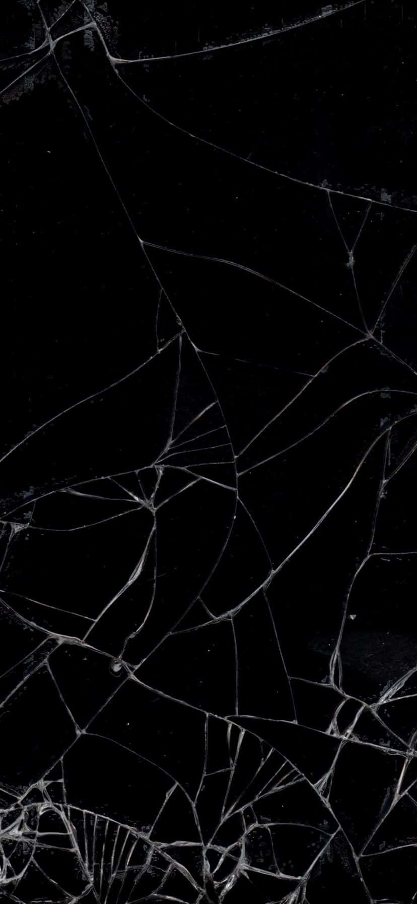 抽象破裂的黑色表面，帶有白色裂紋線形成網狀圖案。