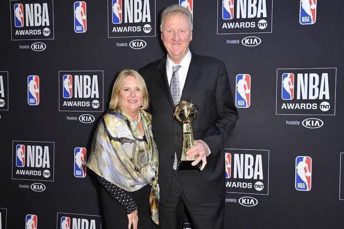 男子和女子在頒獎典禮上與NBA獎盃合影。