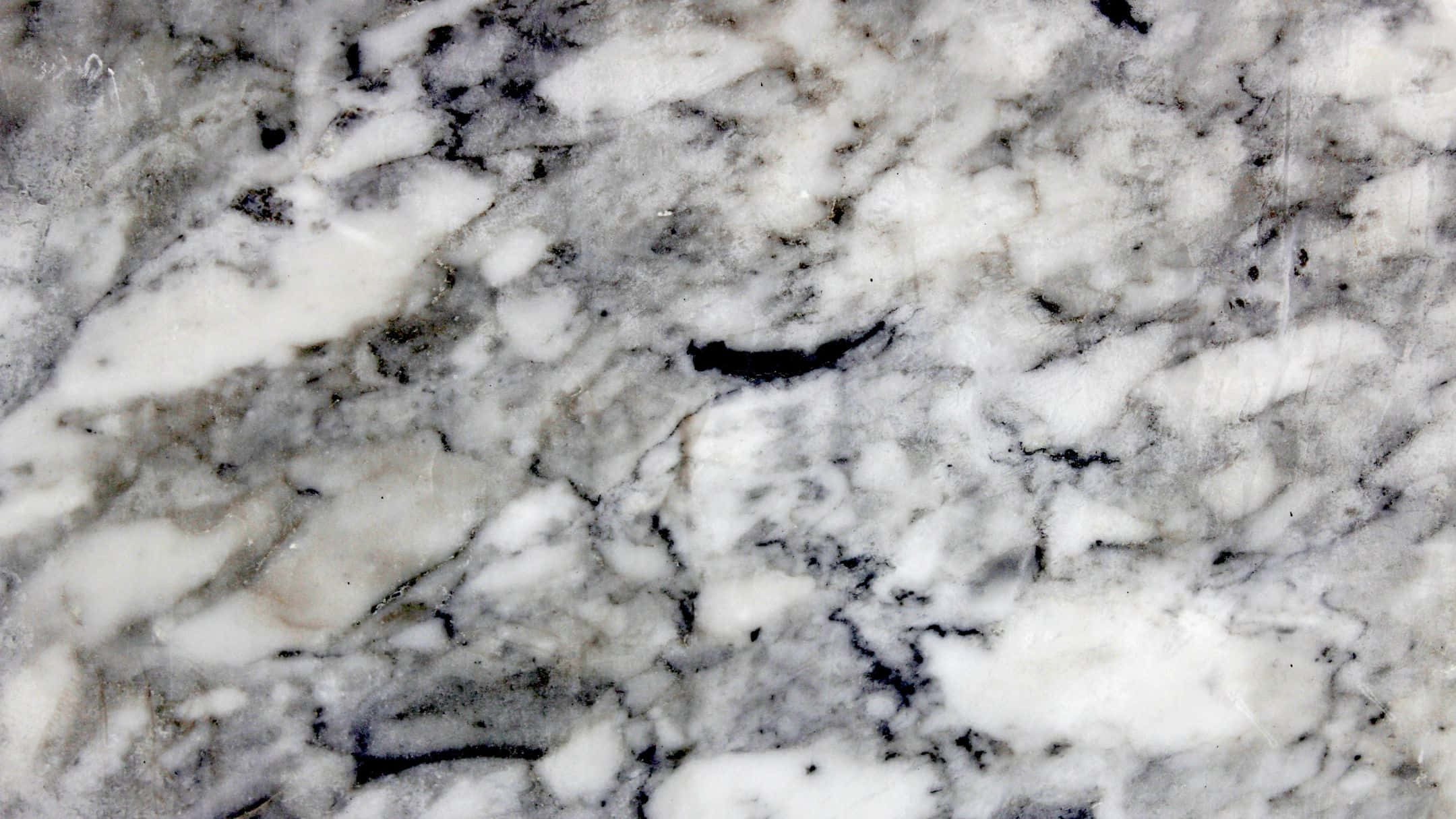 Grey Marble 桌布 壁紙 — 拋光花崗岩表面的特寫，帶有旋轉的白色、灰色和黑色礦物紋理。