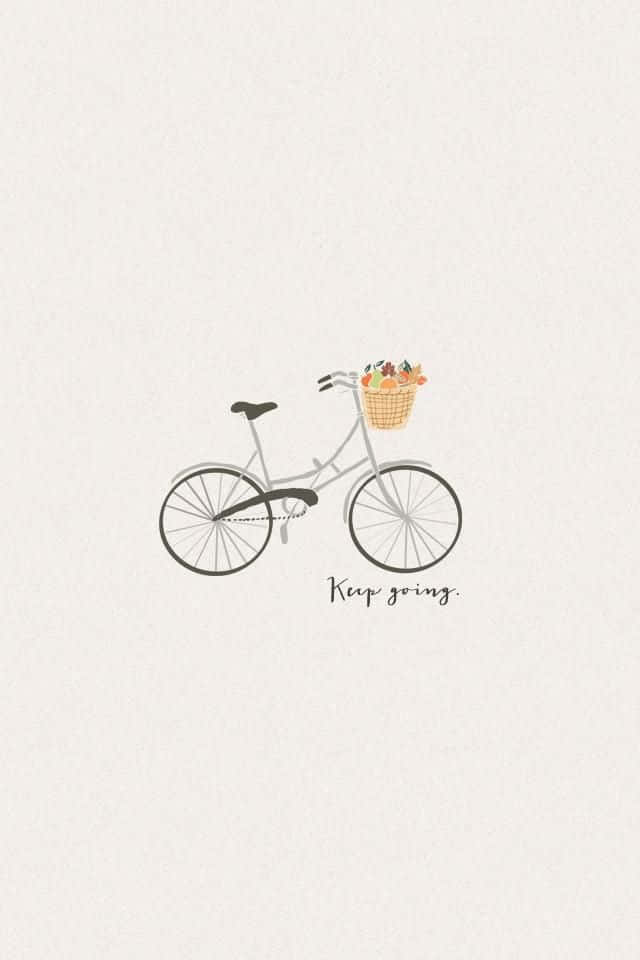 一輛灰色單車，車籃裡裝著秋葉，並帶有「Keep going」字句。