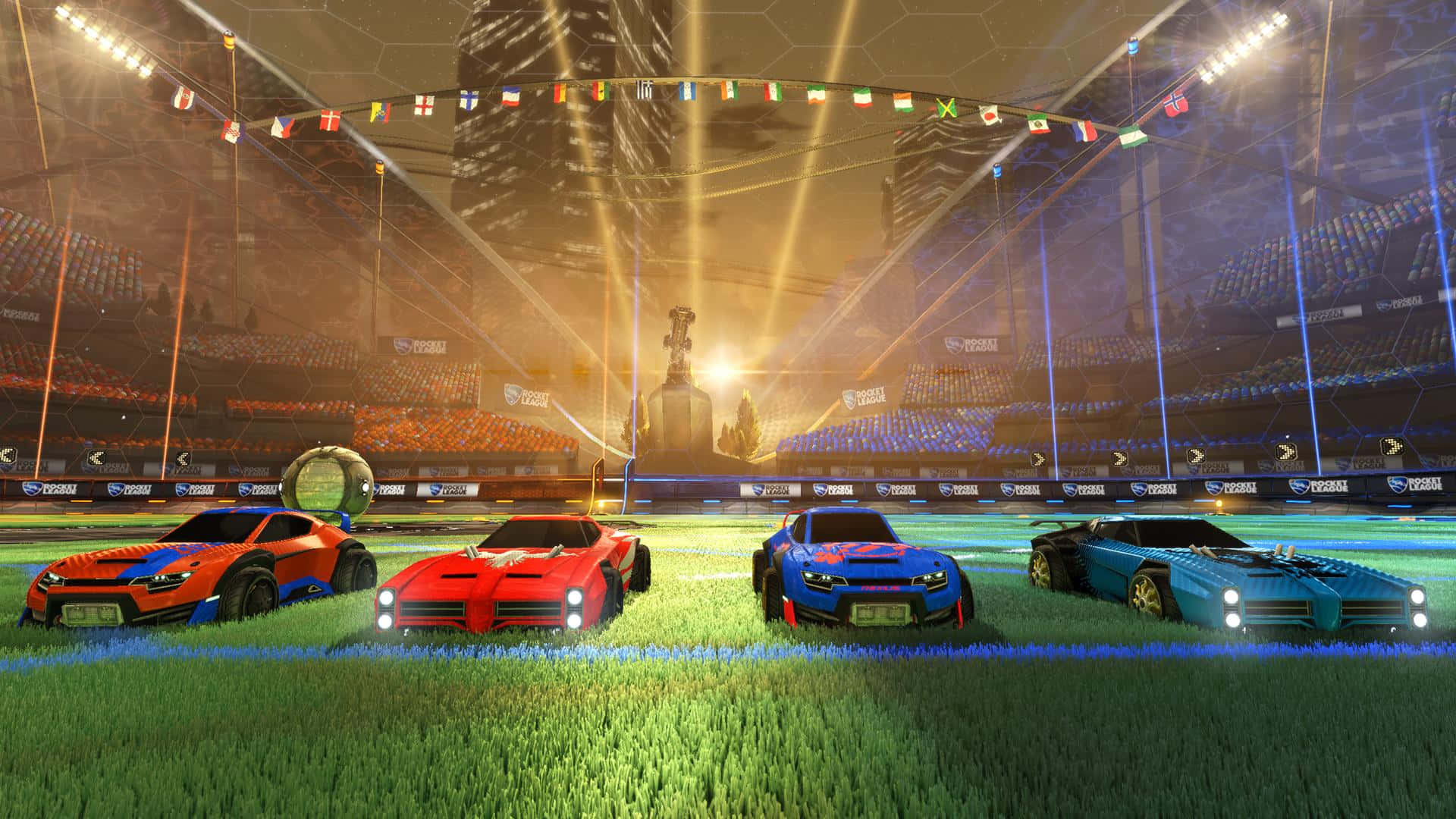 挑戰 Rocket League 中飛躍的足球 壁紙 — 四輛色彩鮮艷的火箭動力賽車在草地賽道上奔馳，體育場燈光下，遠處有獎盃。