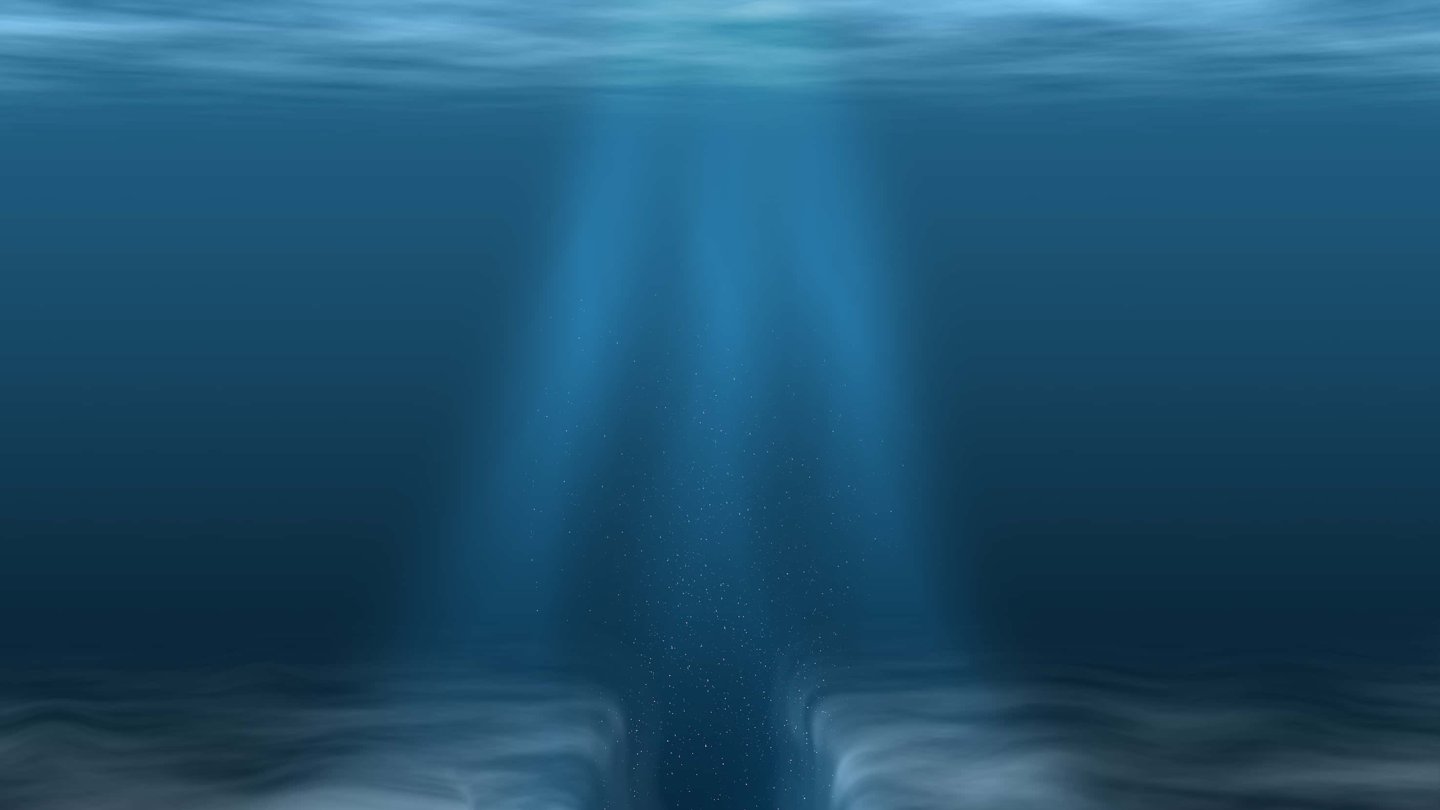 探索令人驚嘆的馬里亞納海溝深處 壁紙 — 陽光光束穿透海洋表面，照亮黑暗海床上漂浮的微粒。