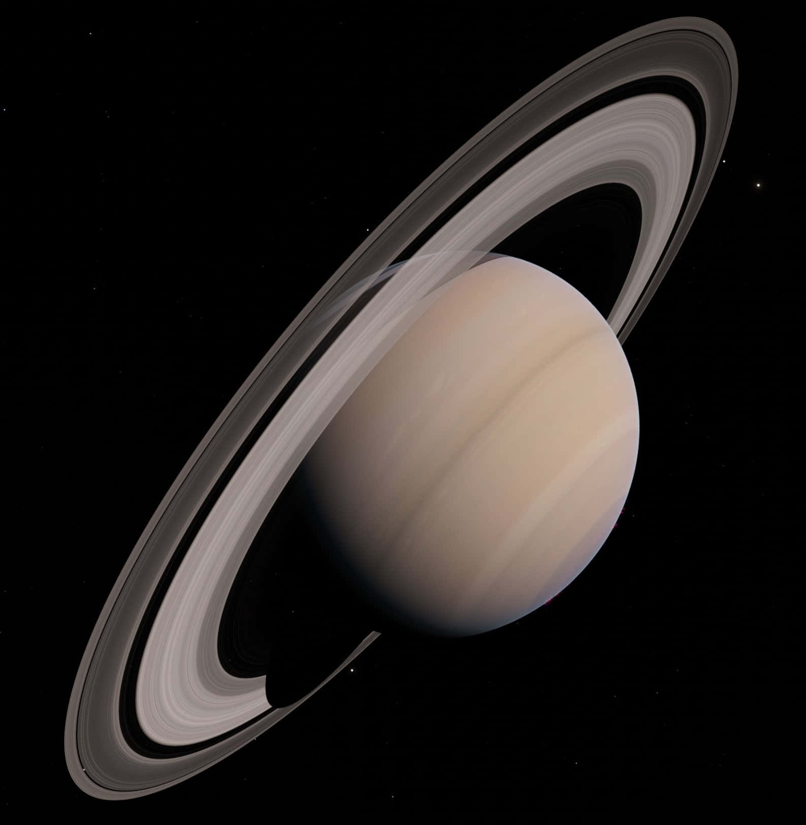 探索土星的奇觀 壁紙 — 土星在虛空中柔和發光，其標誌性光環在深空中投下細膩陰影。