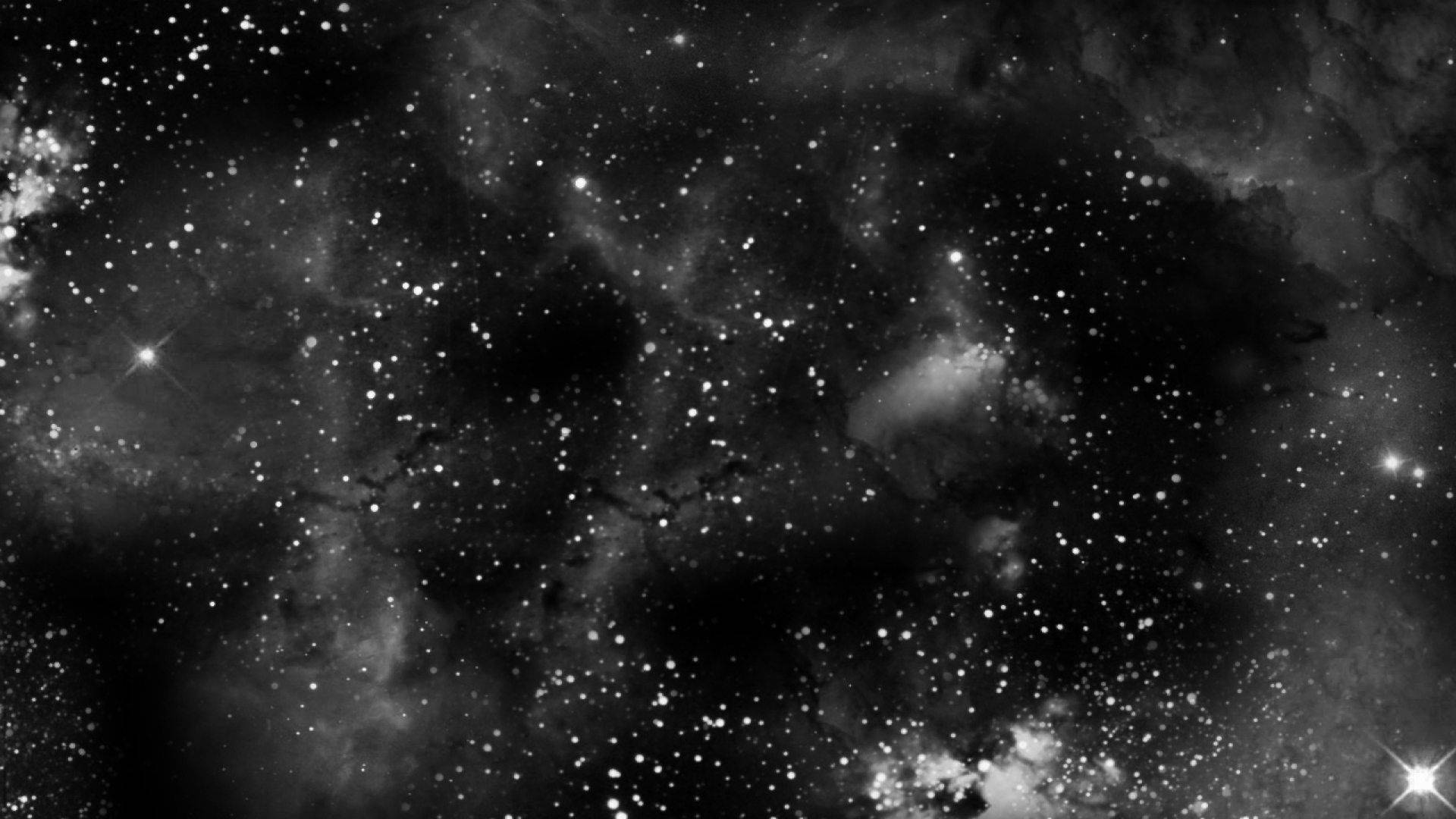 黑白星空，帶有發光的星雲和宇宙塵埃雲。