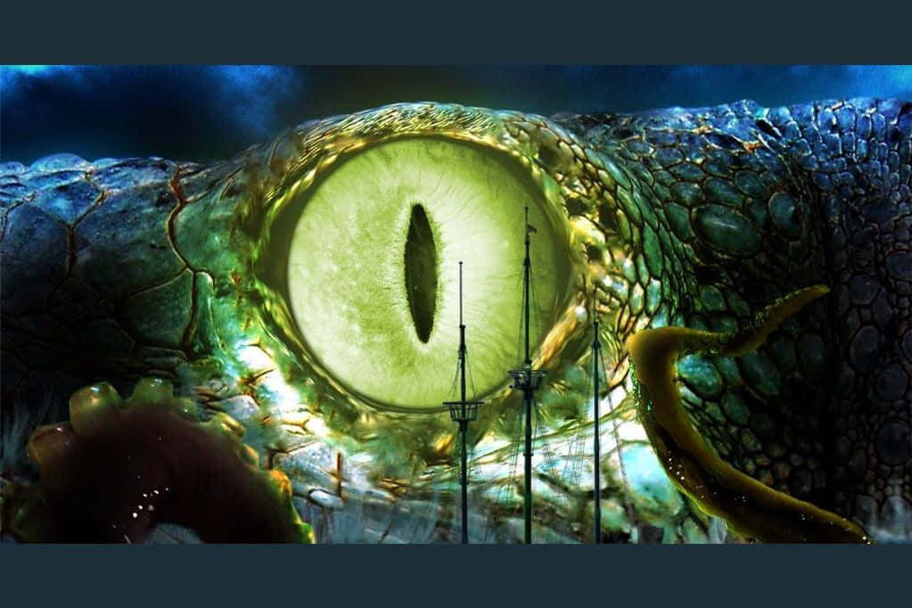 探索恐懼的深海海底世界 壁紙 — 一個巨大生物的發光綠色眼睛佔據了畫面，透過其瞳孔可以看到船桅。