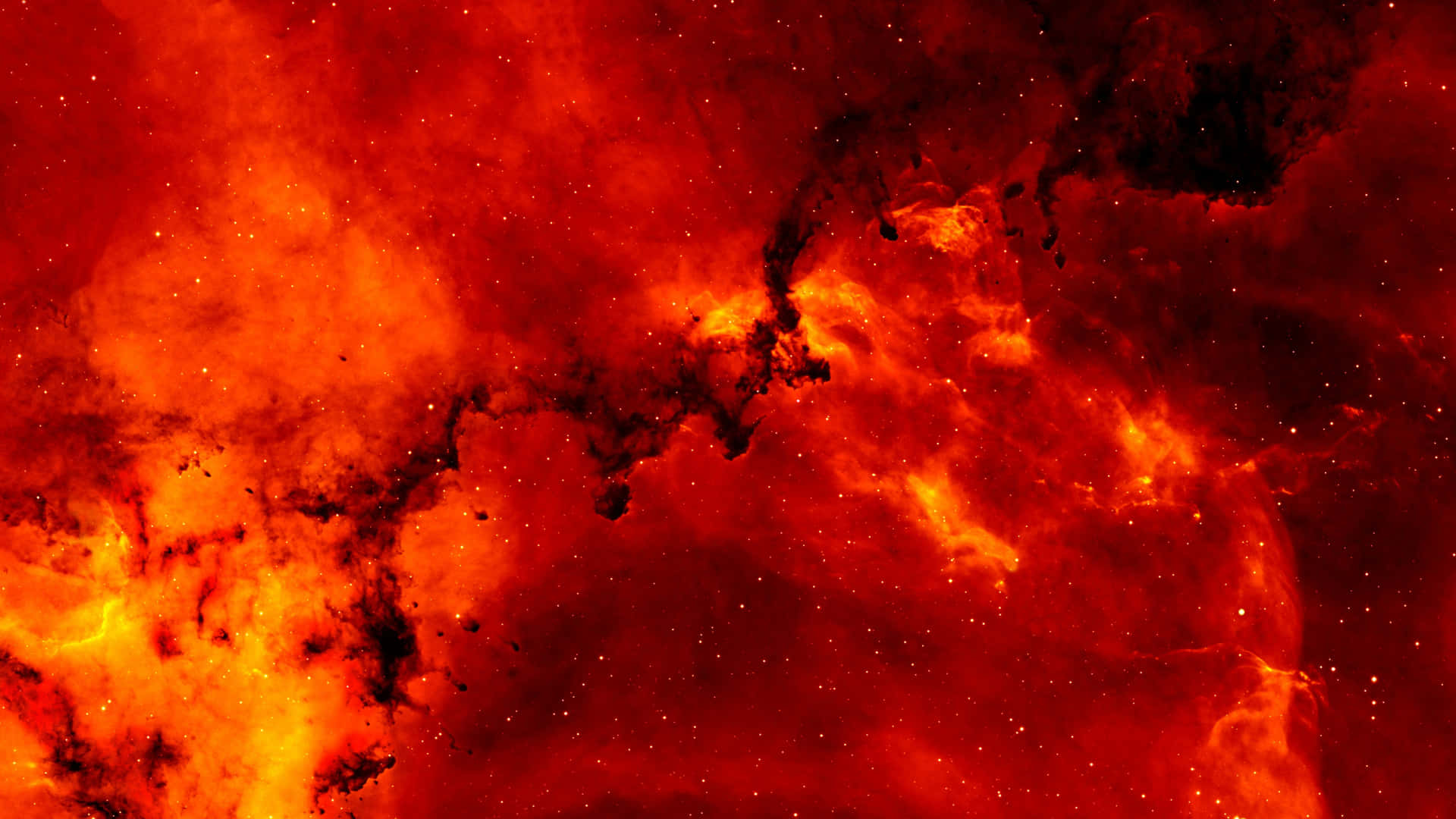 深空中帶有發光星體的火紅和橙色星雲。