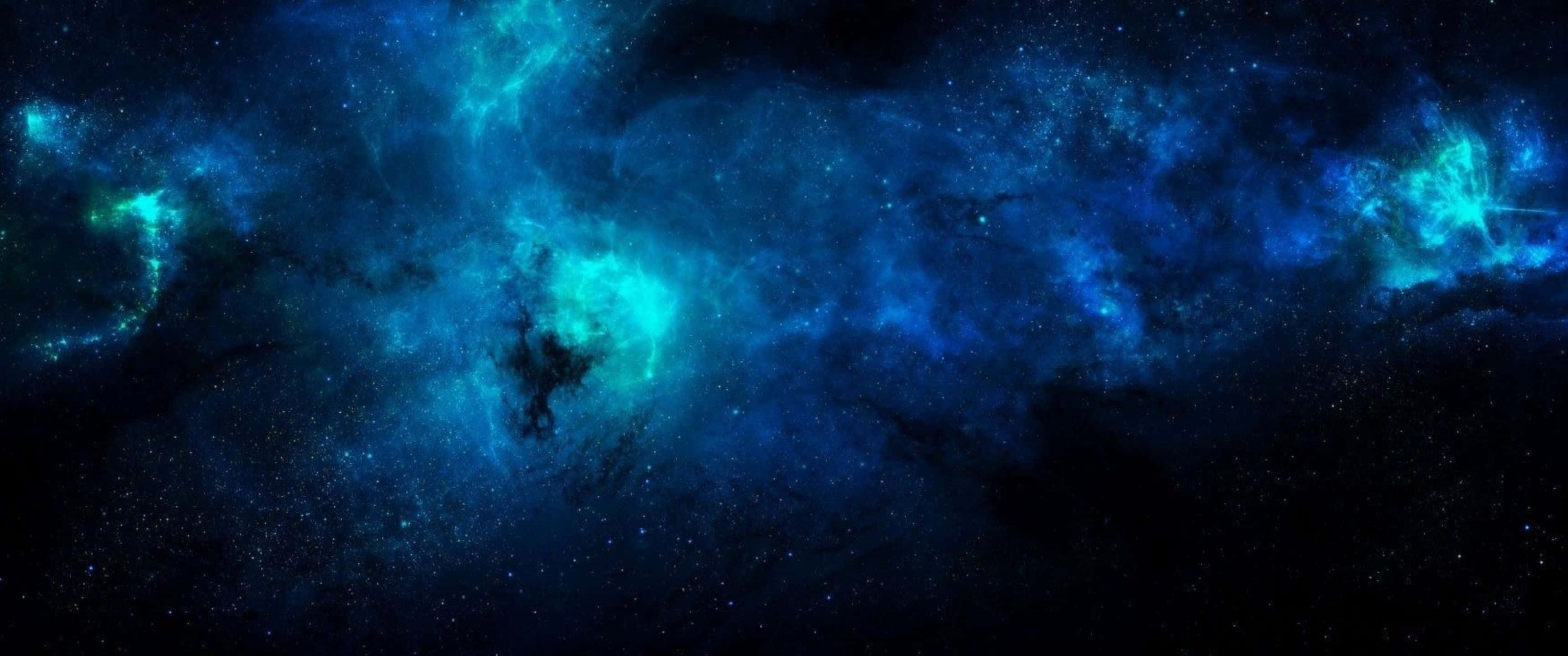 探索藍色宇宙的奇觀 壁紙 — 廣闊的宇宙星雲在佈滿星星的虛空中發出電光藍和藍綠色的光芒。