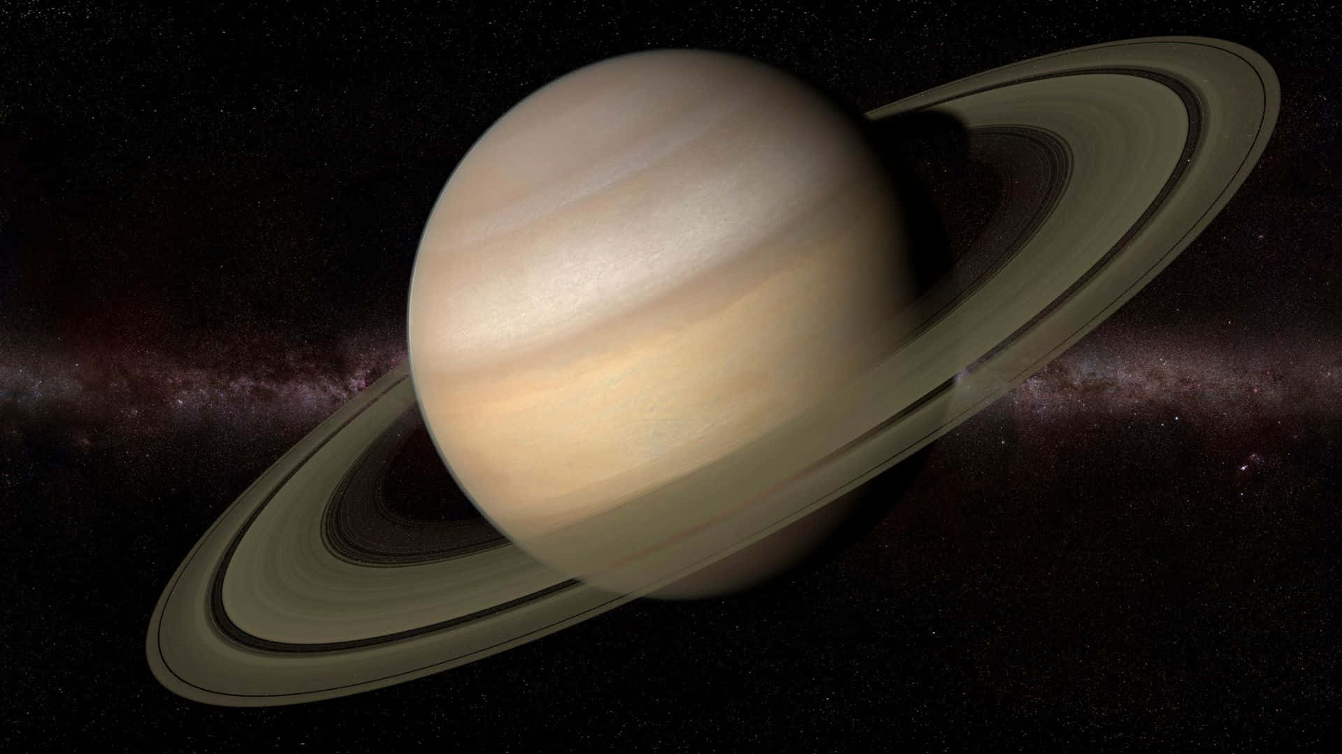 土星光環在太空中對著繁星點點的星雲背景發光。