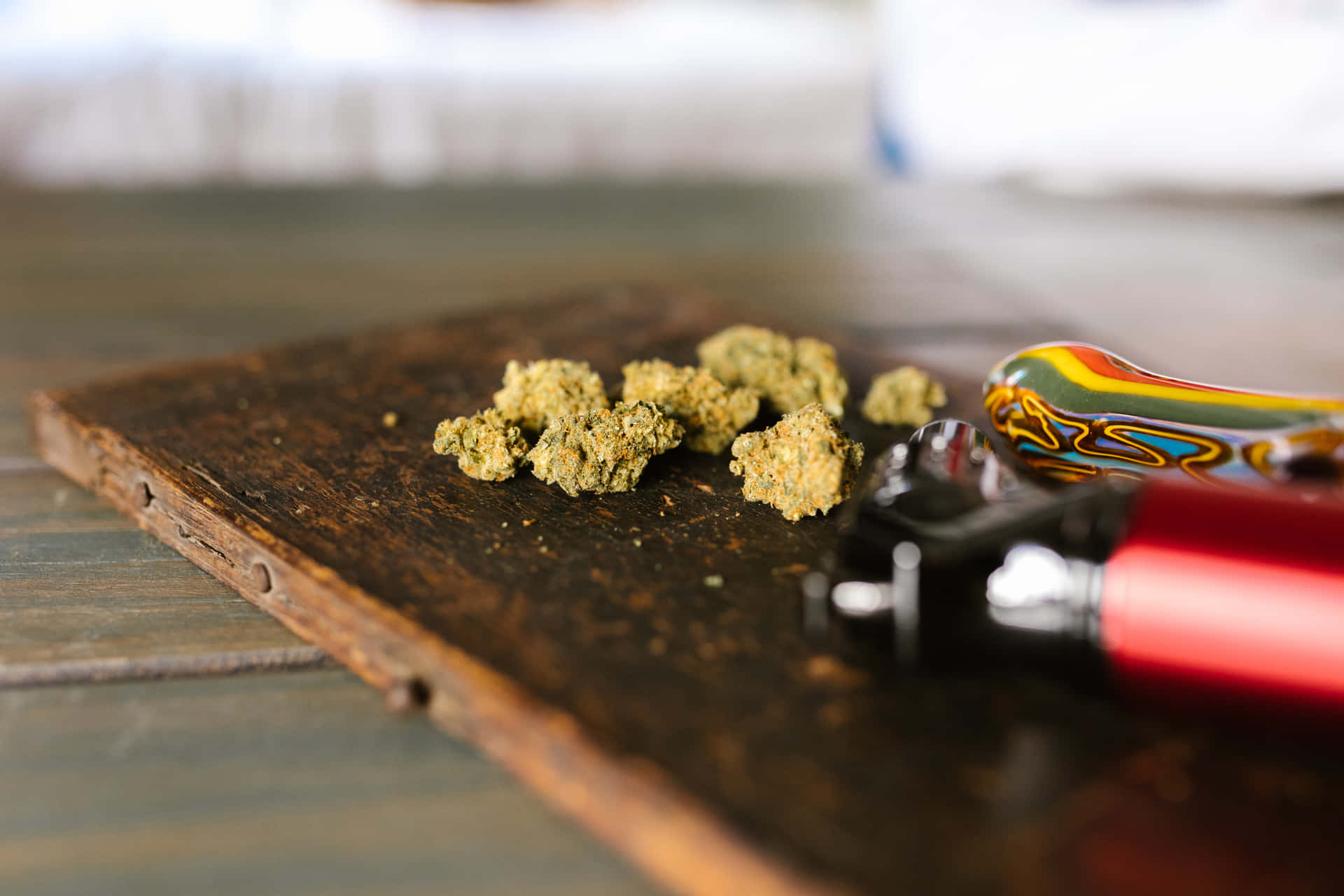 木質表面上的綠色大麻花蕾和彩色煙斗。