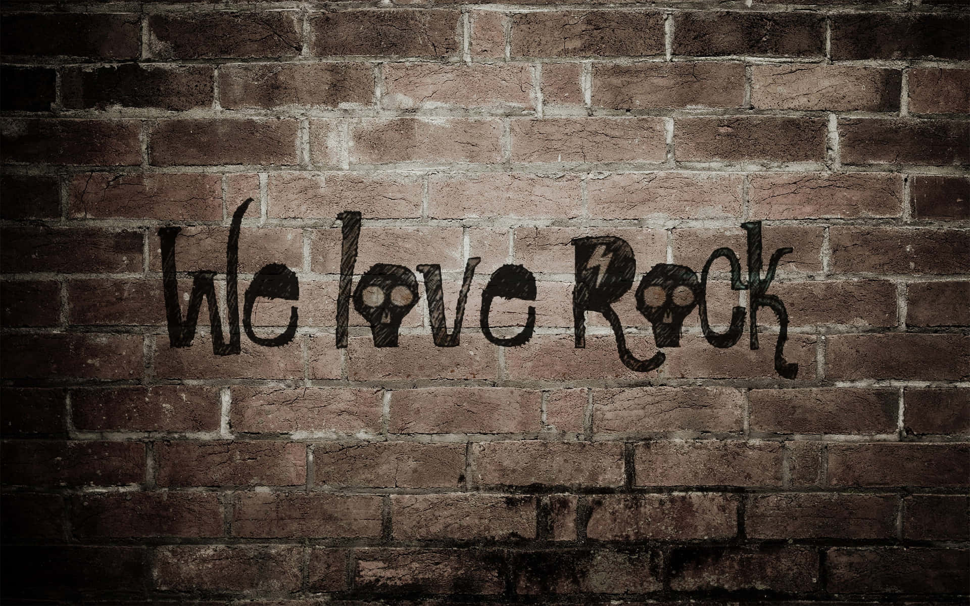磚牆上的塗鴉寫著 We love Rock，帶有骷髏眼睛和閃電。
