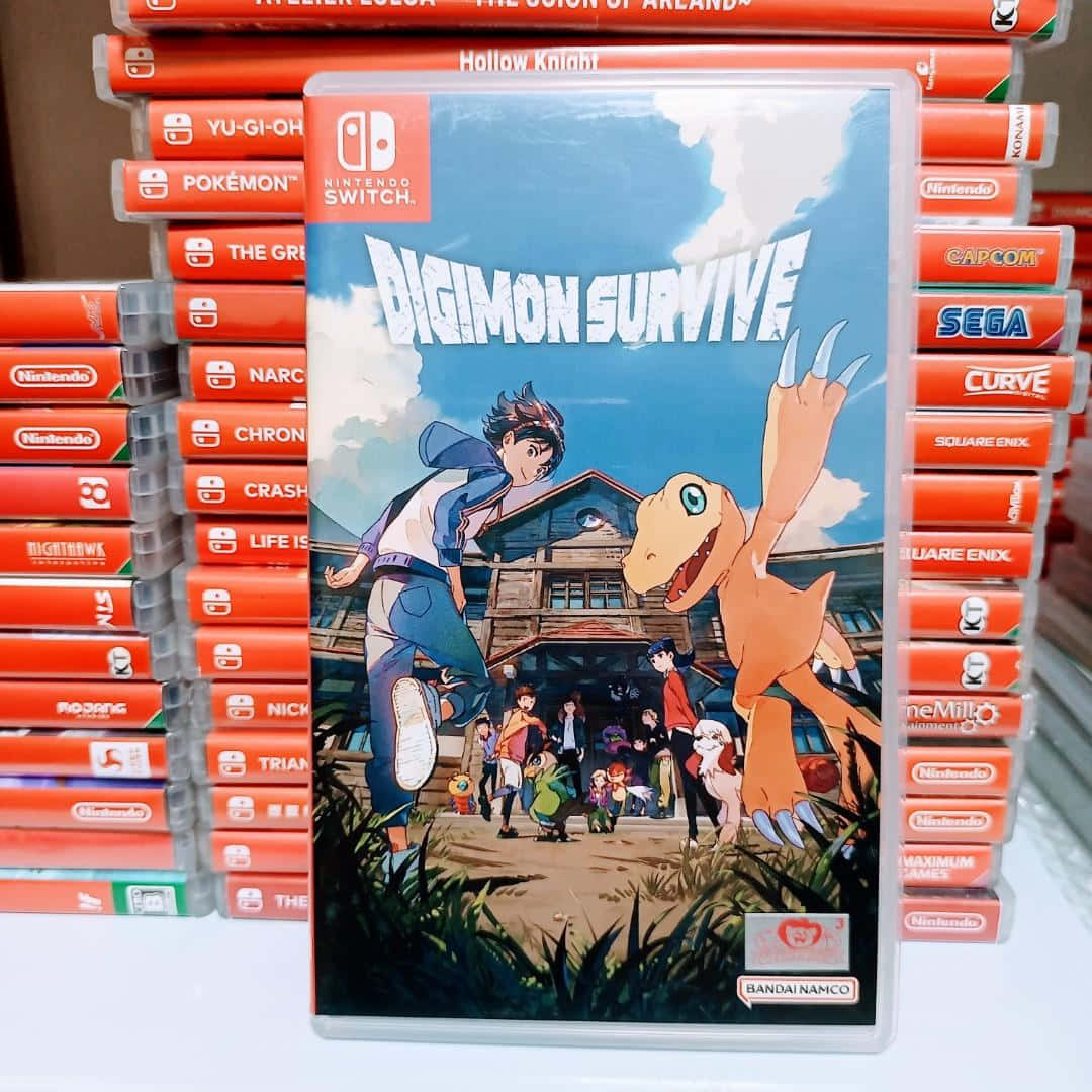 數碼寶貝生存遊戲光碟圖 壁紙 — 一個《Digimon Survive》Nintendo Switch 遊戲盒放在正中央，周圍堆滿其他紅色遊戲卡帶。