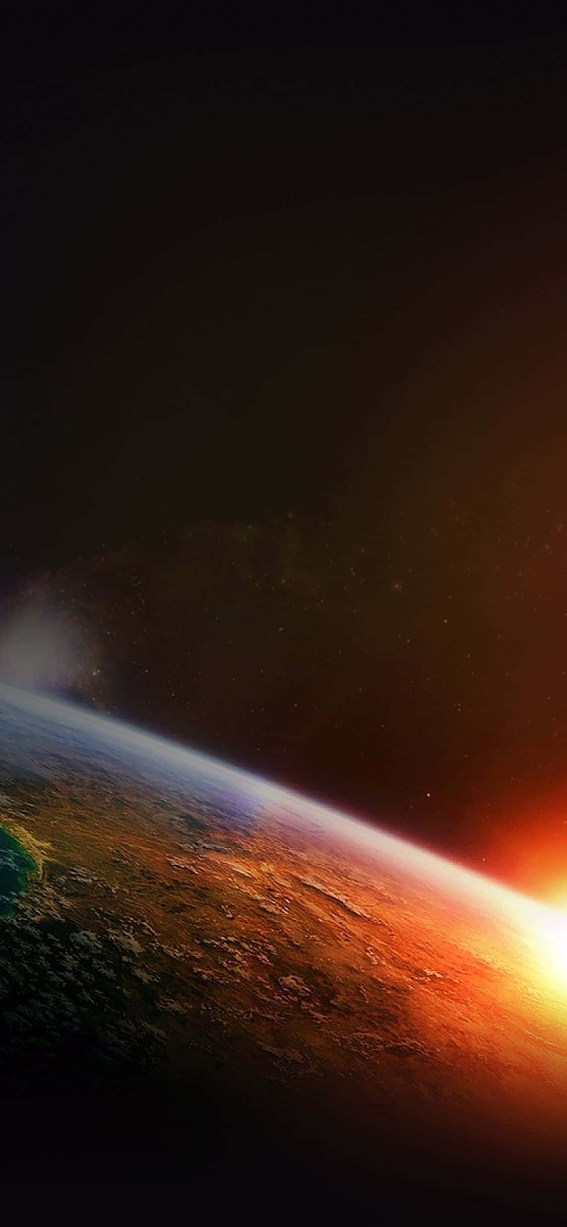 新款iPhone X OLED螢幕 壁紙 — 從太空欣賞地球在日出時的壯麗景色，彎曲的地平線上有鮮豔的橙色和藍色色調。