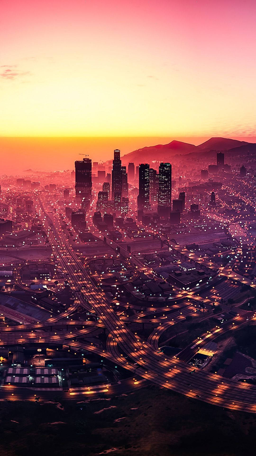 Gta 桌布 壁紙 — 日落時分，在粉橙色天空下，一座廣闊城市的鳥瞰圖，高速公路和摩天大樓閃閃發光。