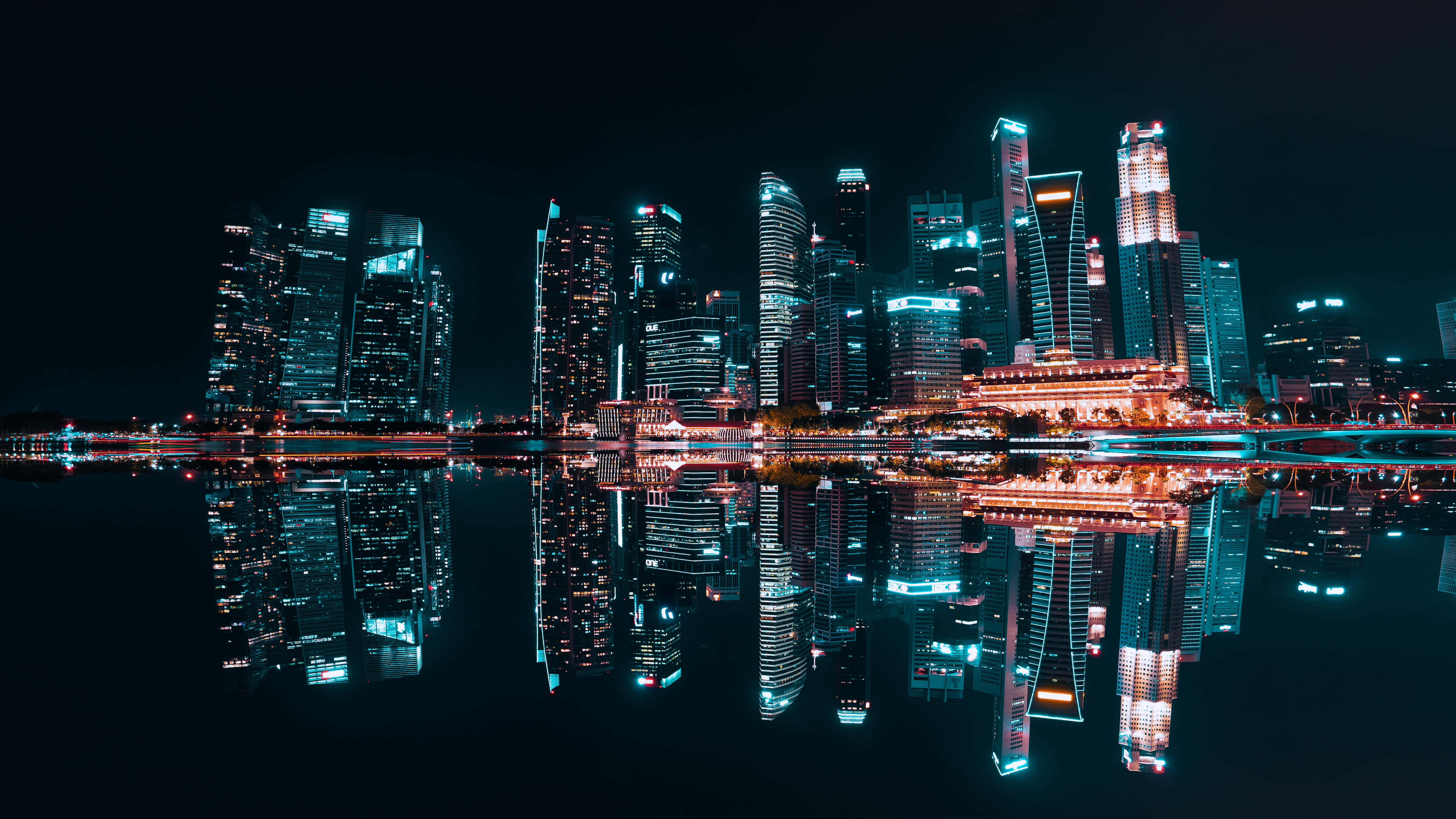 日落時分壯麗天際線 壁紙 — 令人驚嘆的夜景城市景觀，高聳的摩天大樓與充滿活力的霓虹燈完美地倒映在平靜的水面上。
