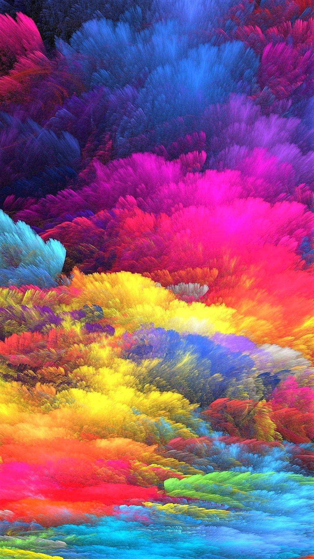 明亮多彩的 iPhone 粉彩雲朵壁紙 壁紙 — 充滿活力的抽象雲朵，霓虹粉、黃、藍、紫色在動態色彩爆炸中旋轉。