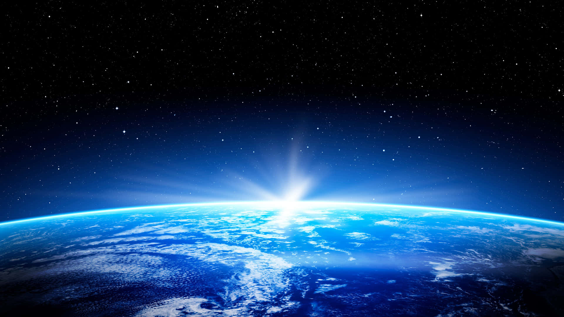 從太空觀看地球日出，發光的大氣層和星空。