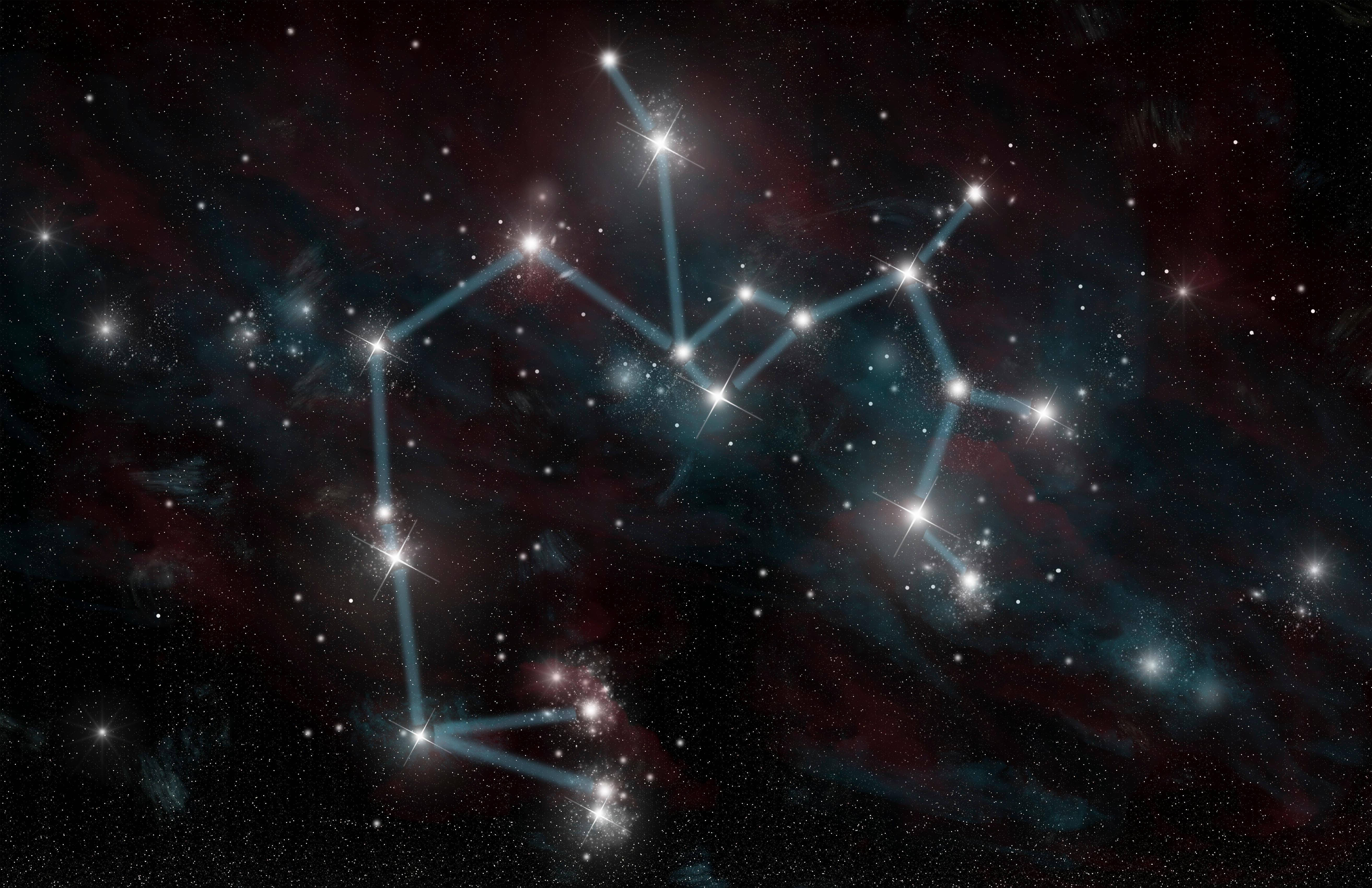 星空中射手座符號 壁紙 — 一個閃耀的星座，以發光的藍色線條勾勒，背景是深邃的宇宙，有紅色和藍綠色的星雲以及閃爍的星星。
