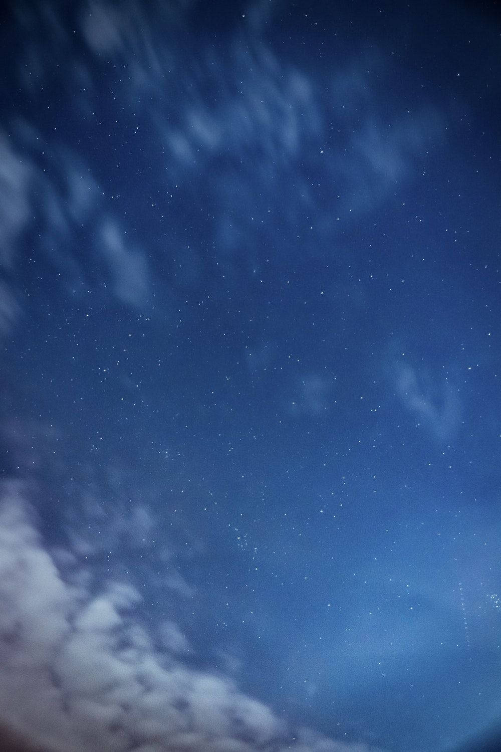 繁星點點的夜空，飄動的雲朵和閃爍的星星。