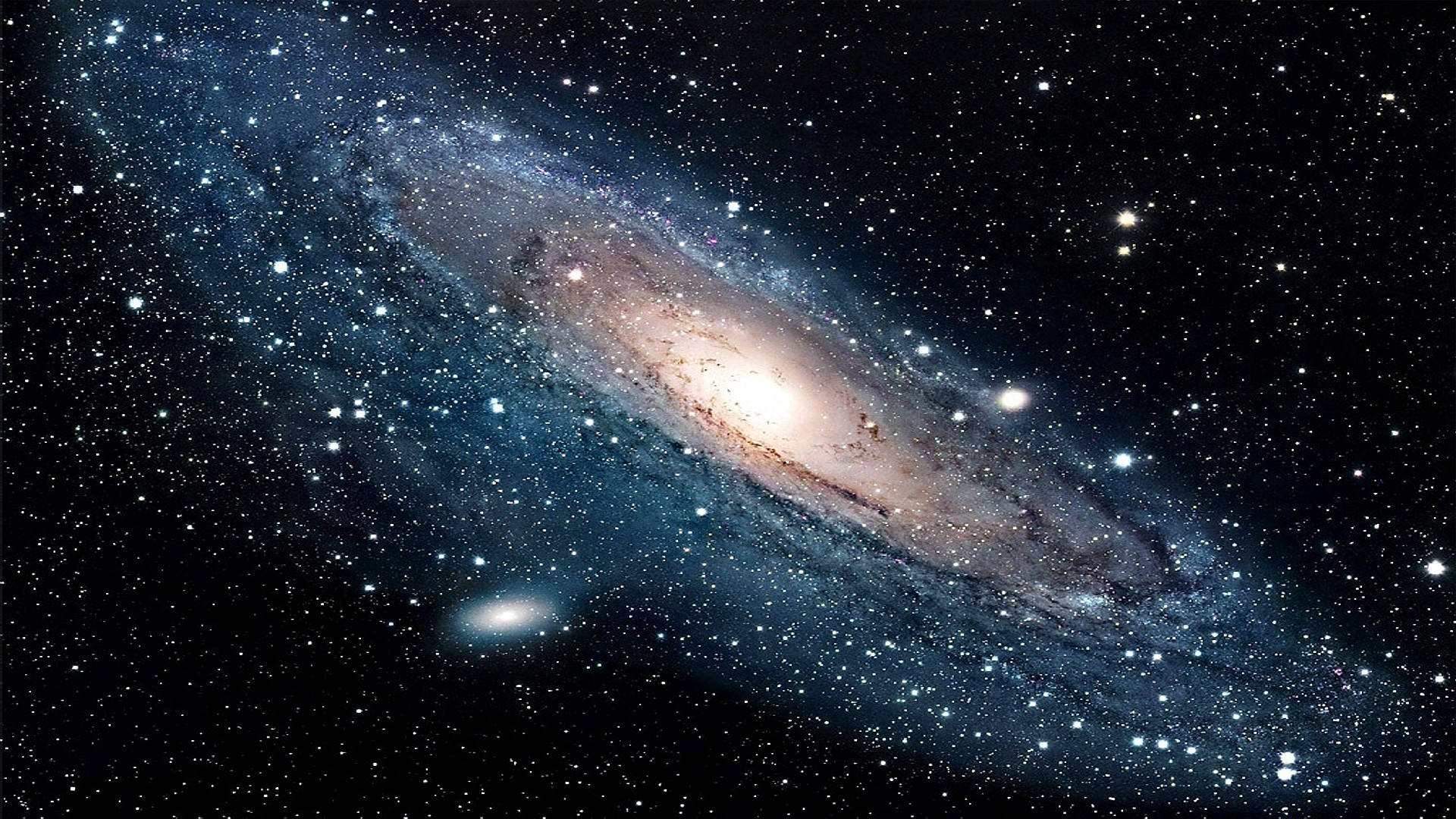星系的太空電腦壁紙 壁紙 — 一個雄偉的螺旋星系，在佈滿星辰的宇宙虛空中，閃耀著藍色和金色的漩渦臂。