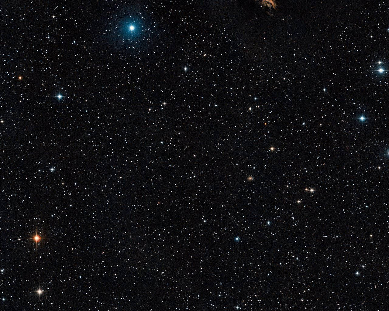 繁星點點的夜空，明亮的藍色和橙色星星散落在黑色虛空中。
