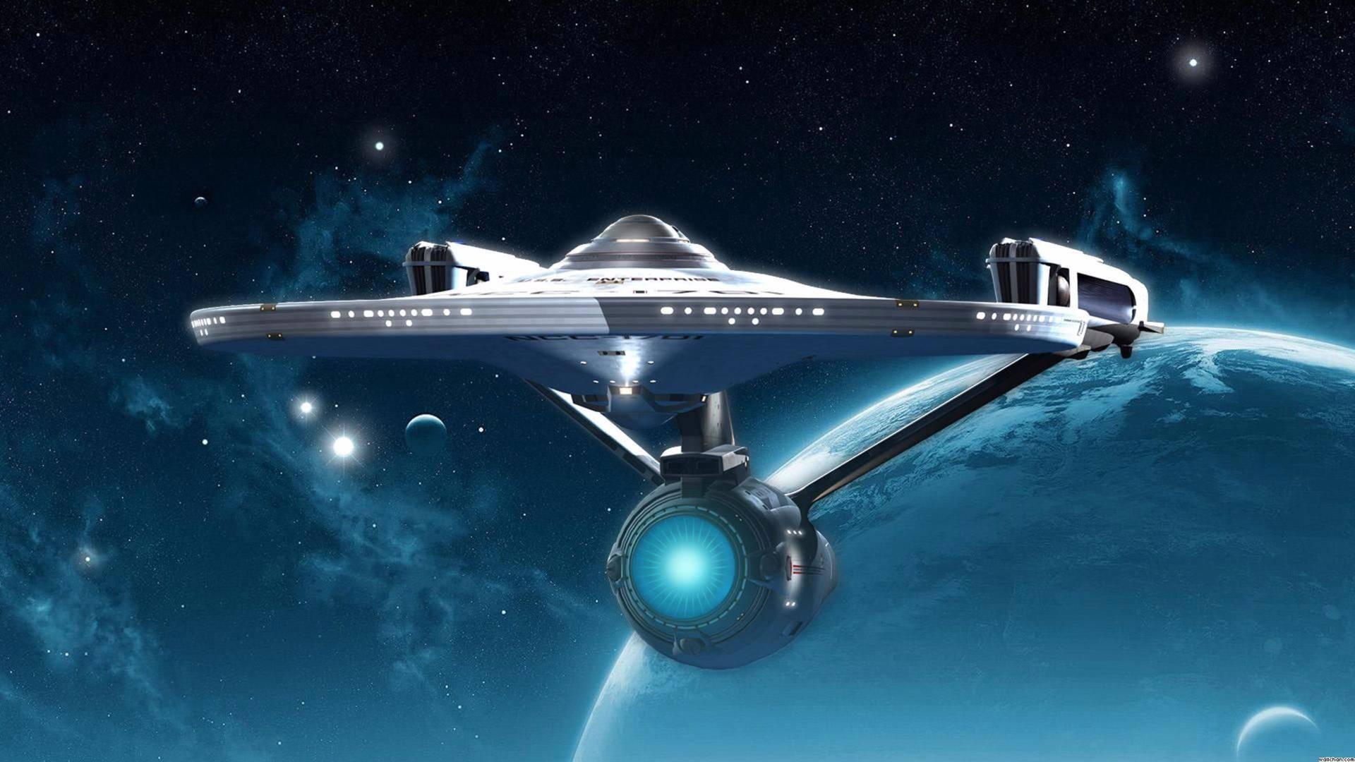 未來派飛船在佈滿星星的天空中環繞藍色行星。 — 星際迷航 壁紙