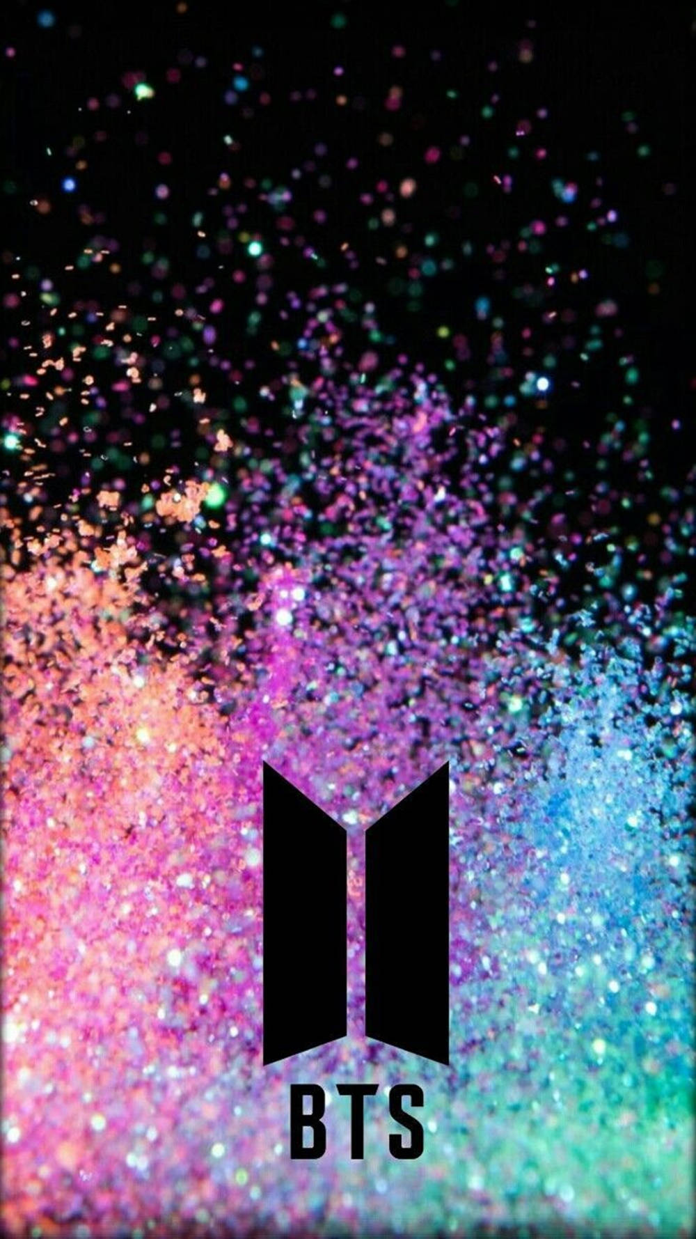 BTS標誌被彩色閃粉粒子包圍在深色背景上。 — BTS標誌 壁紙