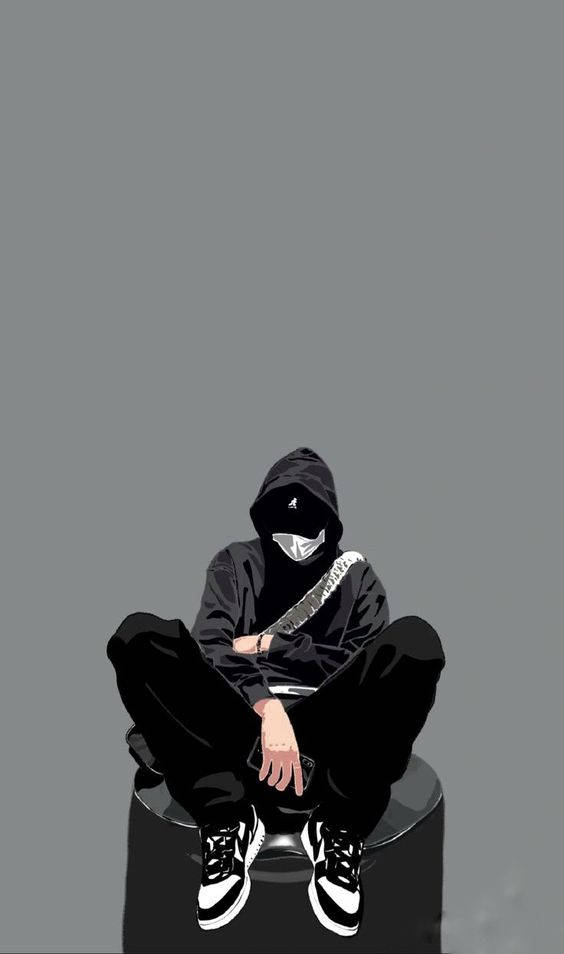 穿著黑色連帽衫和口罩的人坐在灰色背景前的凳子上。