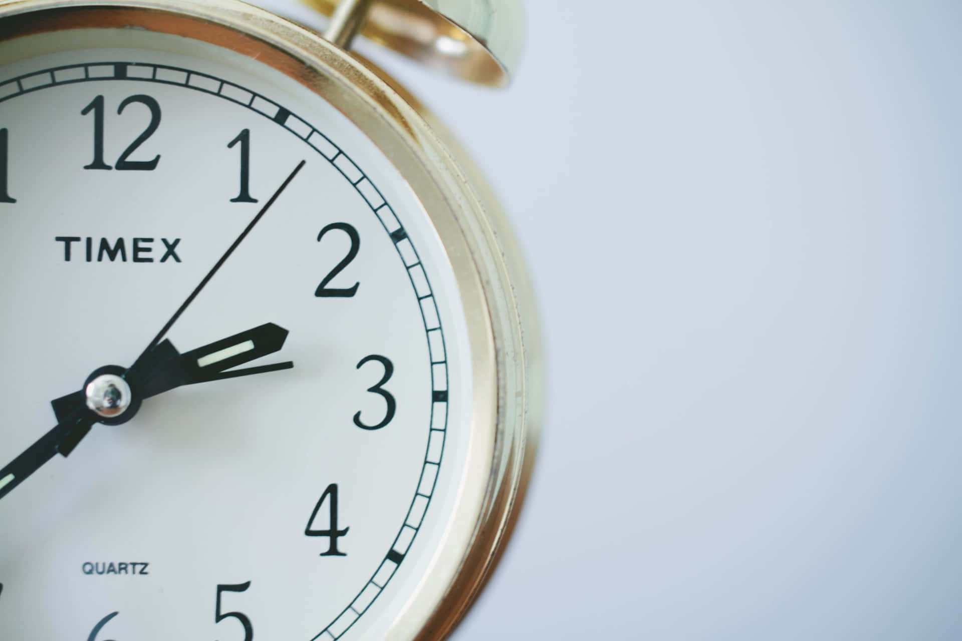 復古Timex鬧鐘，金色外殼配白色錶面。