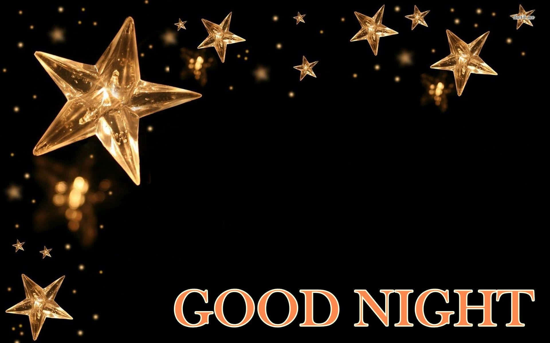 晚安金星圖 壁紙 — 金色發光的星星在黑色背景上漂浮，帶有暖橙色的「GOOD NIGHT」文字。
