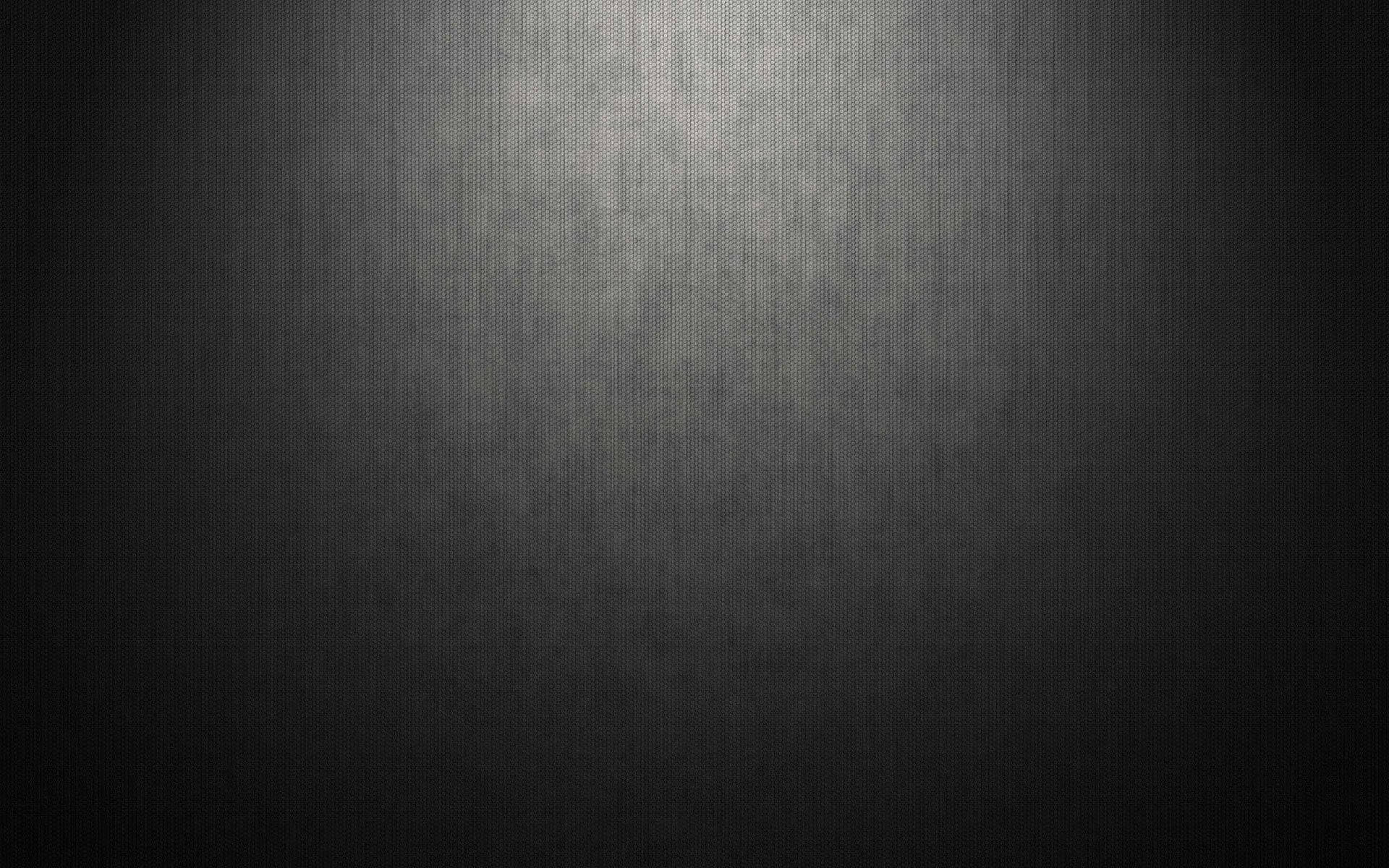 黑暗紋理表面，帶有從中心到邊緣的聚光燈漸變。