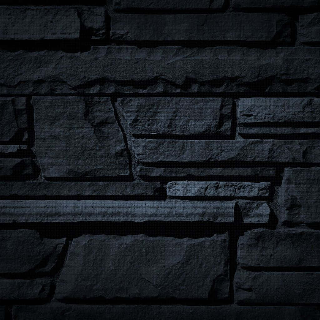 Dark Wall 桌布 壁紙 — 暗色紋理石牆，在低光下呈現深色陰影和粗糙表面。