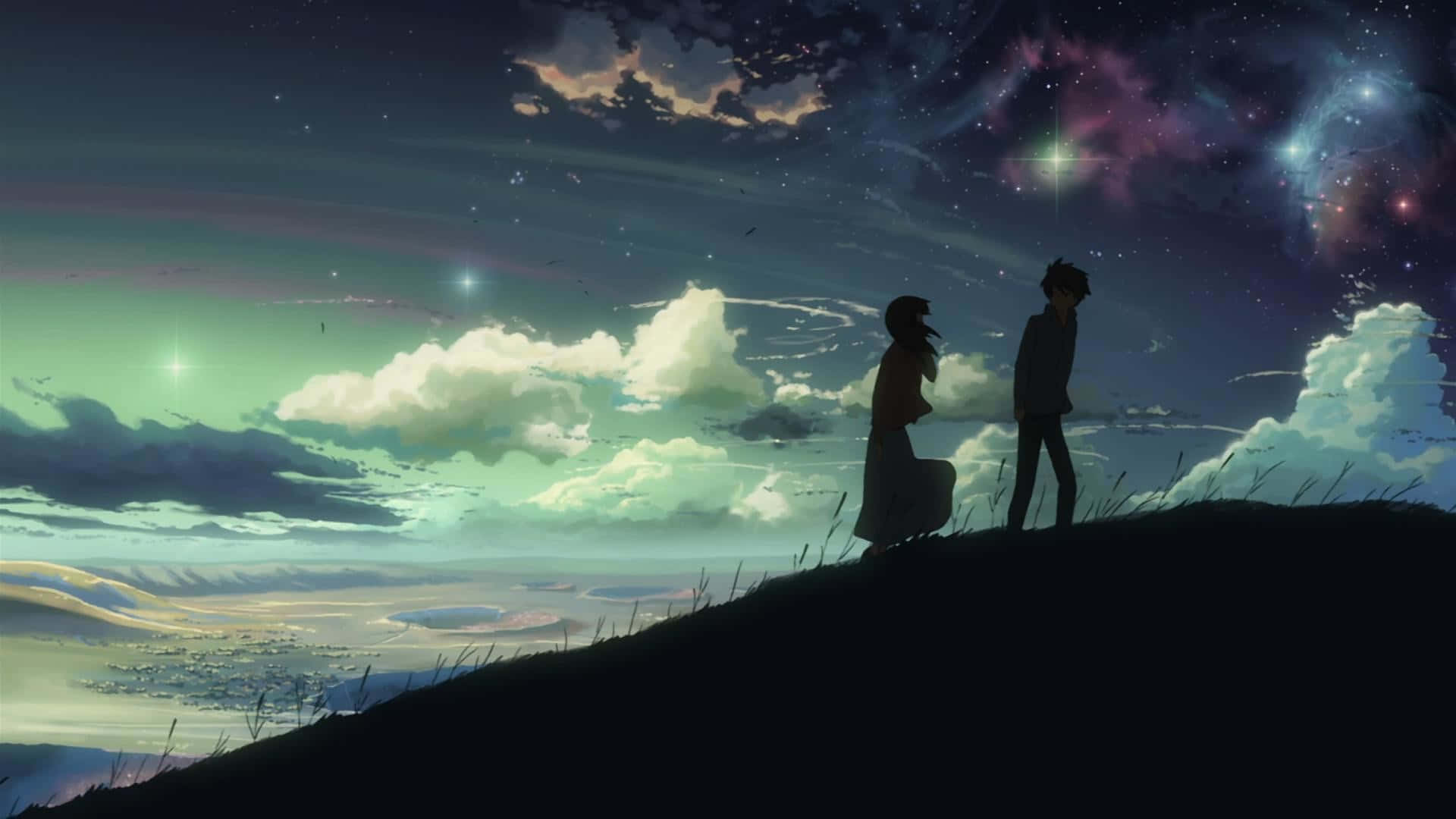 兩個人在山丘上的剪影，在星空下，有色彩繽紛的星雲和雲彩。
