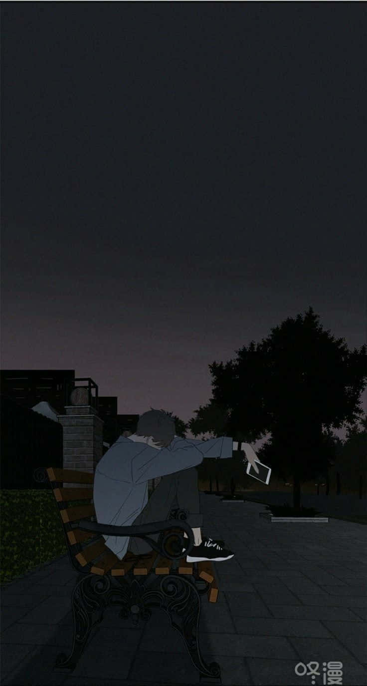 夜晚獨自坐在長椅上手持電話的人