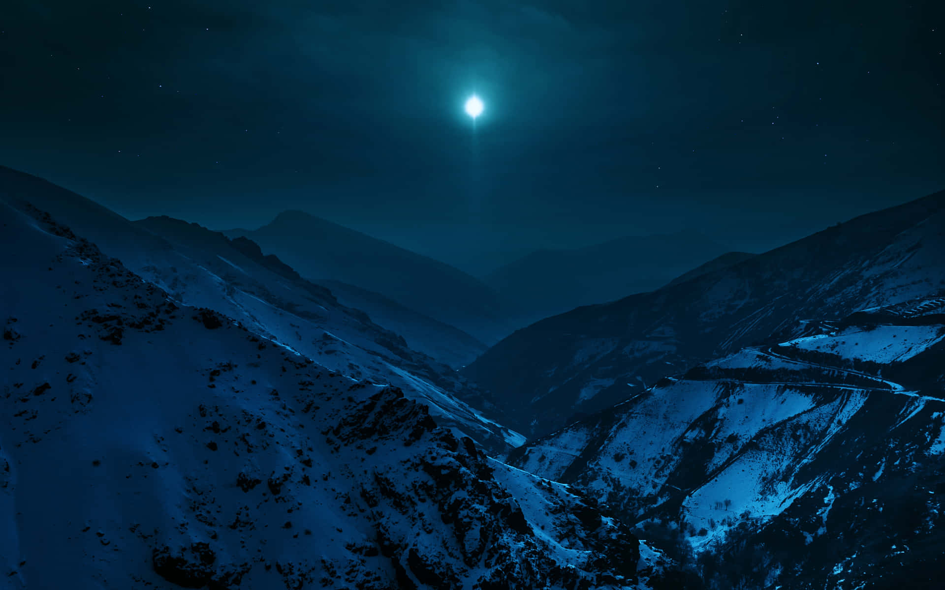 雪覆蓋的山谷，明亮的月亮和星空