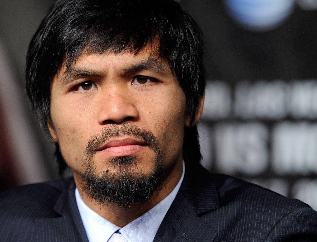 Manny Pacquiao 身穿西裝在記者會上表情嚴肅。