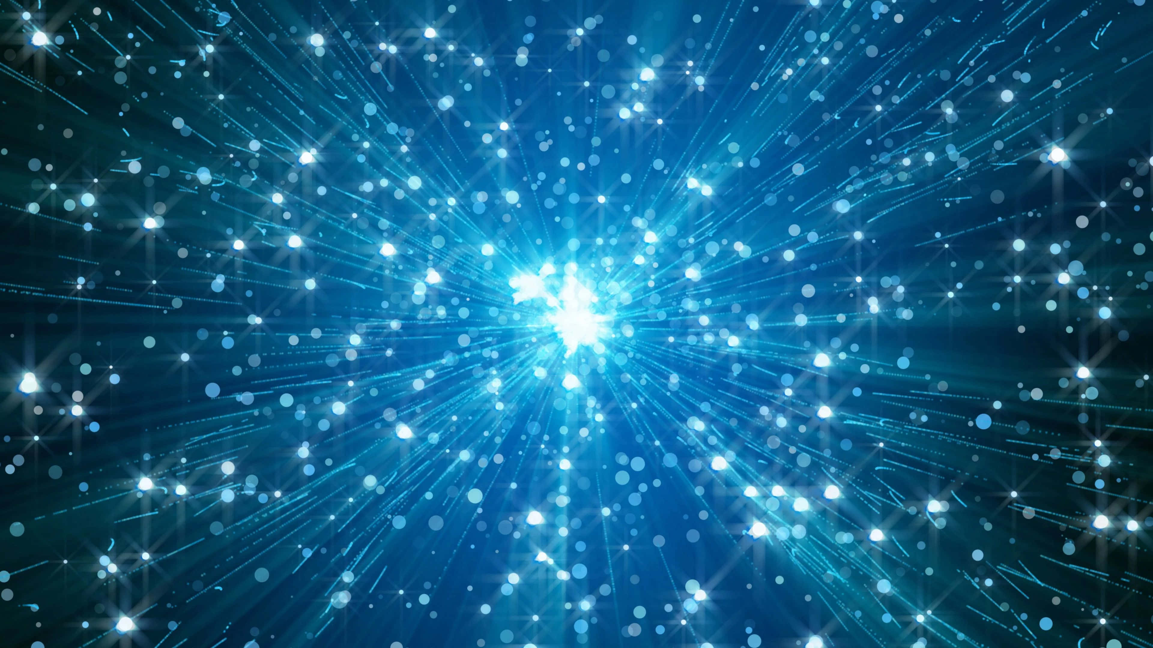 最亮閃耀藍色背景 壁紙 — 從中央光源散發出閃爍粒子與星光的藍色宇宙爆發。