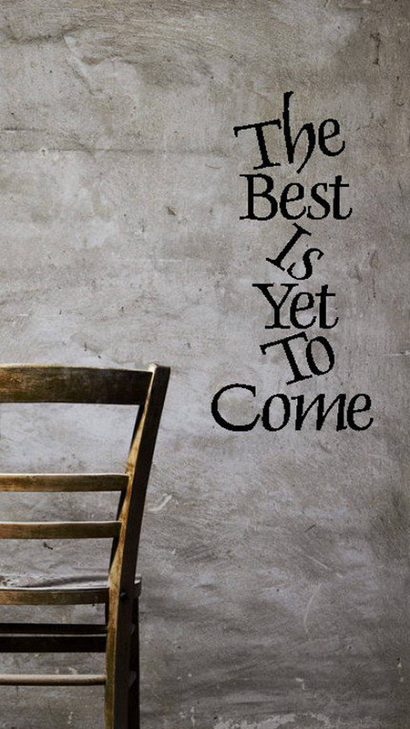 一張木椅旁邊的牆上寫著 The Best Is Yet To Come。