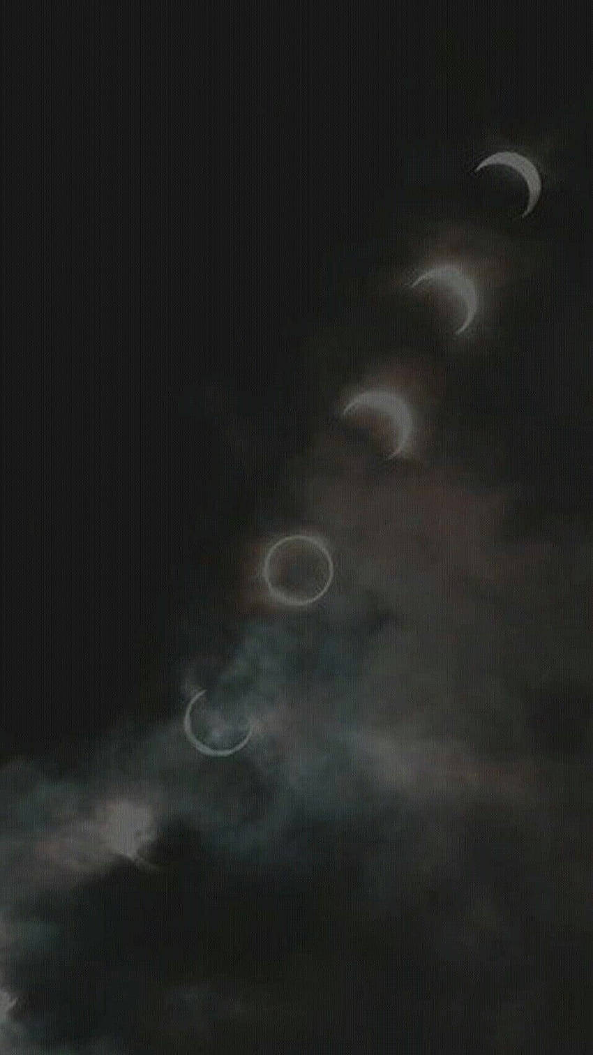 月食期間一系列月相透過夜間雲層可見。